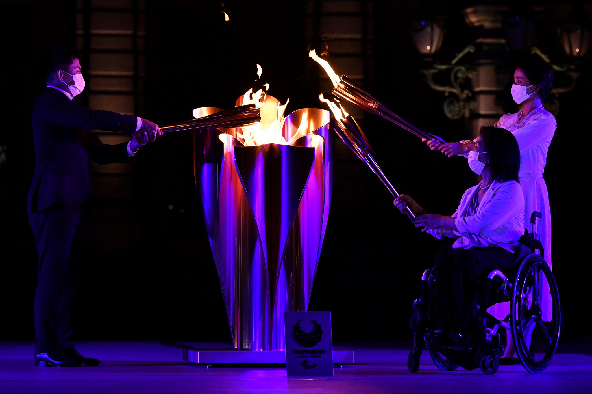 Tadahiro Nomura, Aki Taguchi and Satomi Ishihara, left to right, lit the Paralympic Cauldron ©Getty Images
