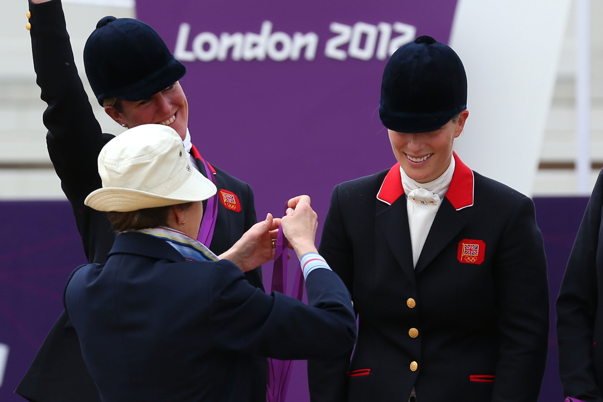 Princess Anne, centre, presents a silver medal to daughter Zara Phillips, right, at London 2012 ©Getty Images