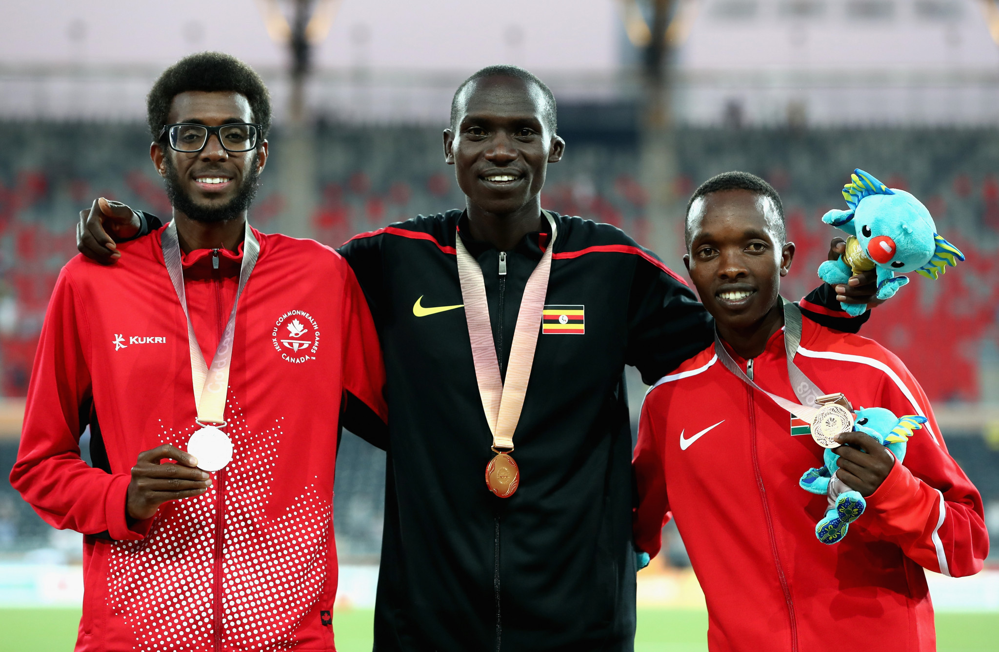 Joshua Cheptegei, centre, twice ensured that the Ugandan anthem was heard at Gold Coast 2018 ©Getty Images