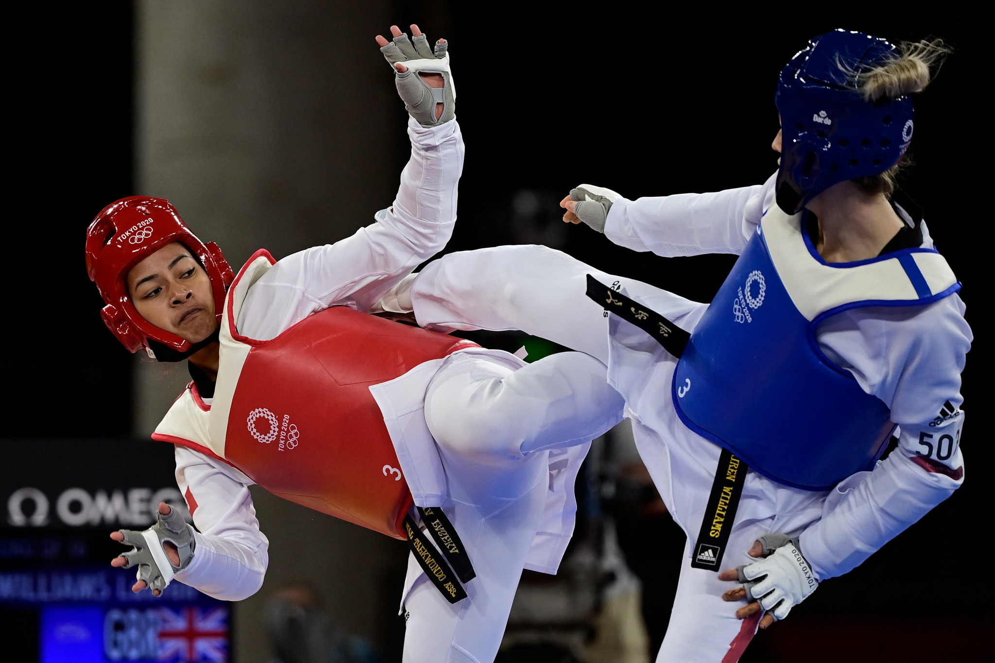 Malia Paseka, red, competed in the women's under-67kg taekwondo at Tokyo 2020, and is one of the members of Tonga's team awaiting a flight home ©Getty Images