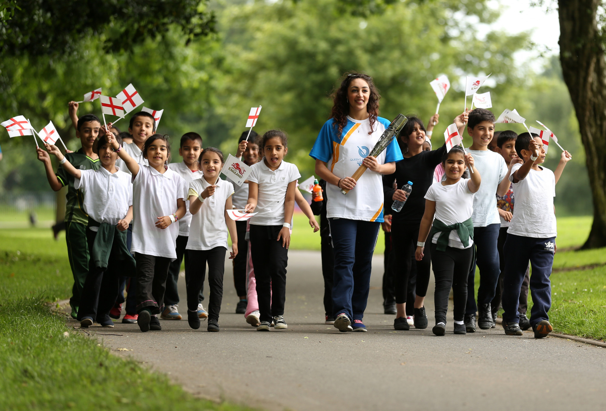 Mimi Cesar was joined by schoolchildren in carrying the Baton in Birmingham before Glasgow 2014 ©Getty Images