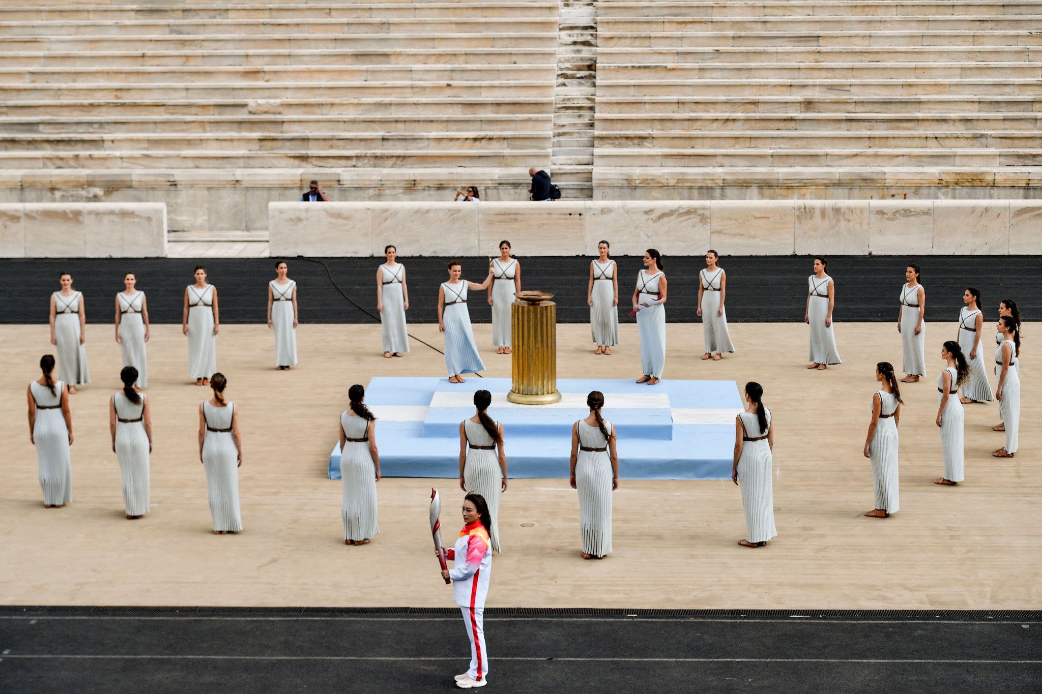 Li Nina holds the Olympic Torch in the Panathenaic Stadium during the Olympic Flame Handover Ceremony ©Getty Images 