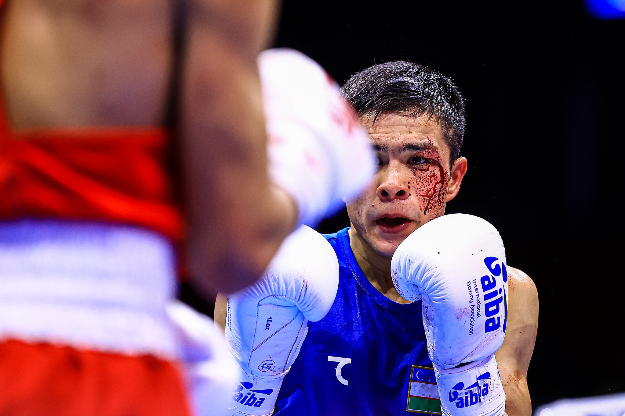 Nodirjon Mirzakhmedov of Uzbekistan suffered a cut in his bout with Kazakh Temirtas Zhussupov ©AIBA