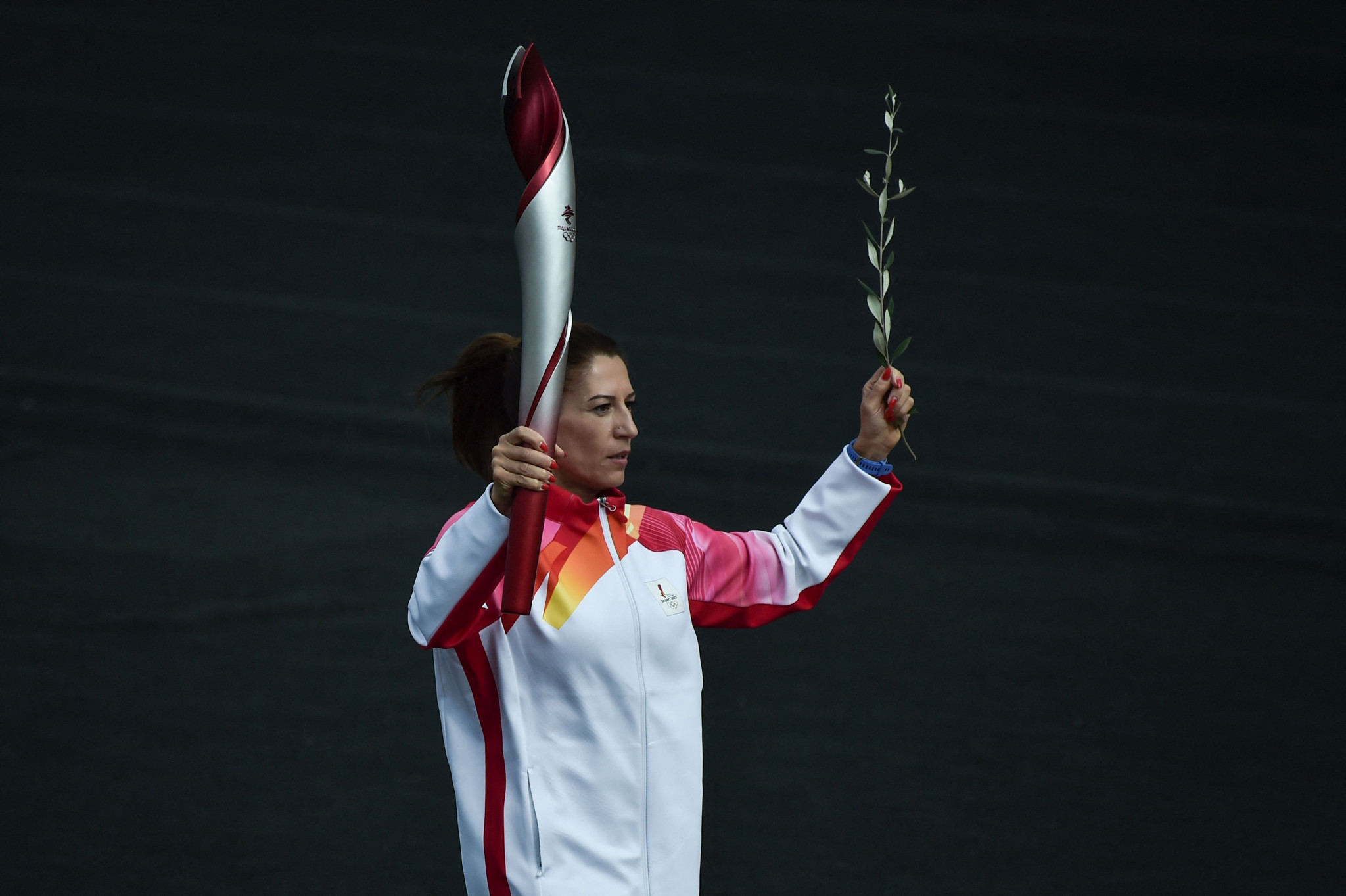 Paraskevi Ladopoulou enters the Panathenaic Stadium with the Torch during the Beijing 2022 Olympic Flame Handover Ceremony ©Getty Images