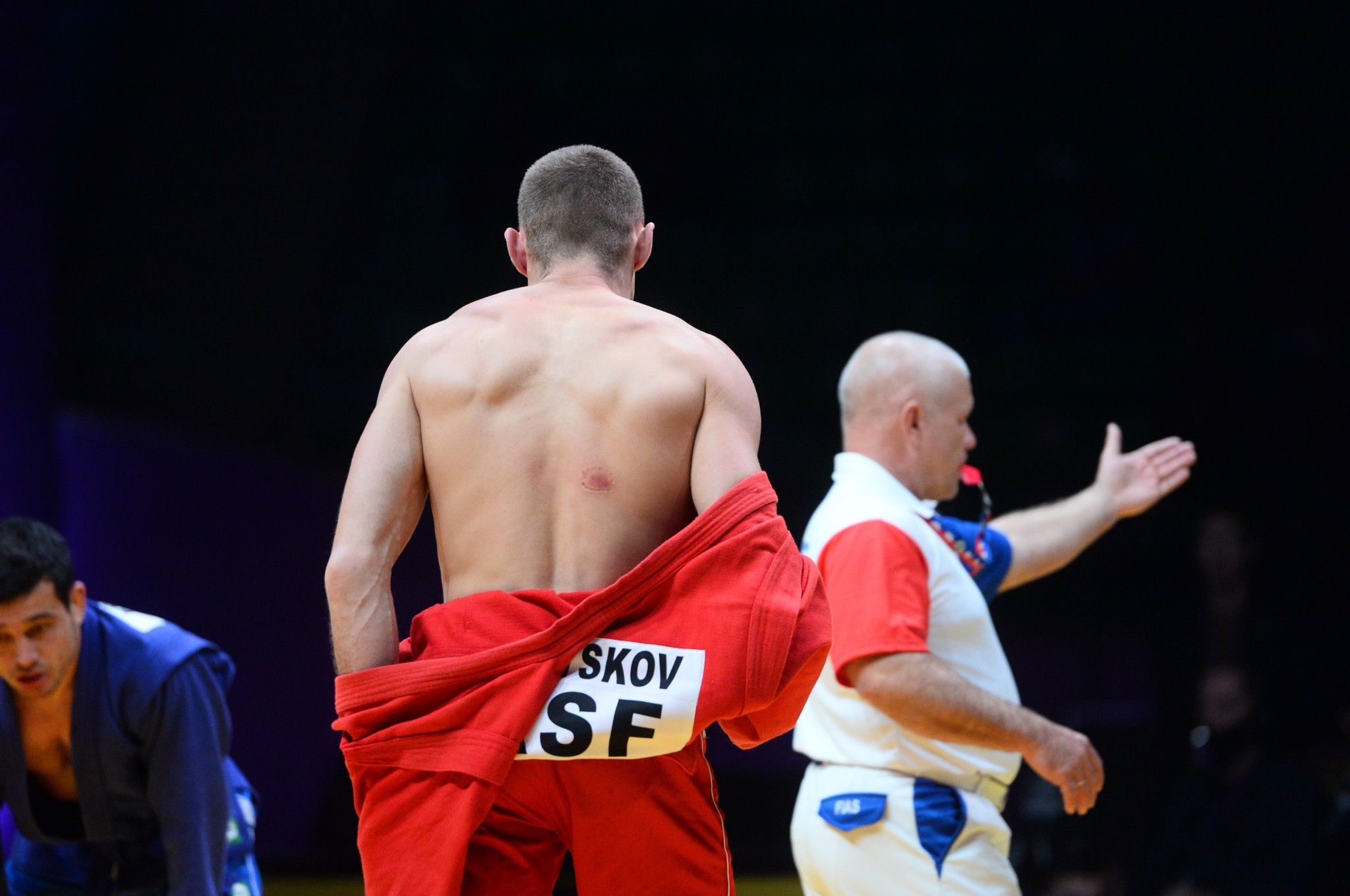 Nikita Kletskov takes off his uniform to show what appears to be a bite mark on his back ©FIAS
