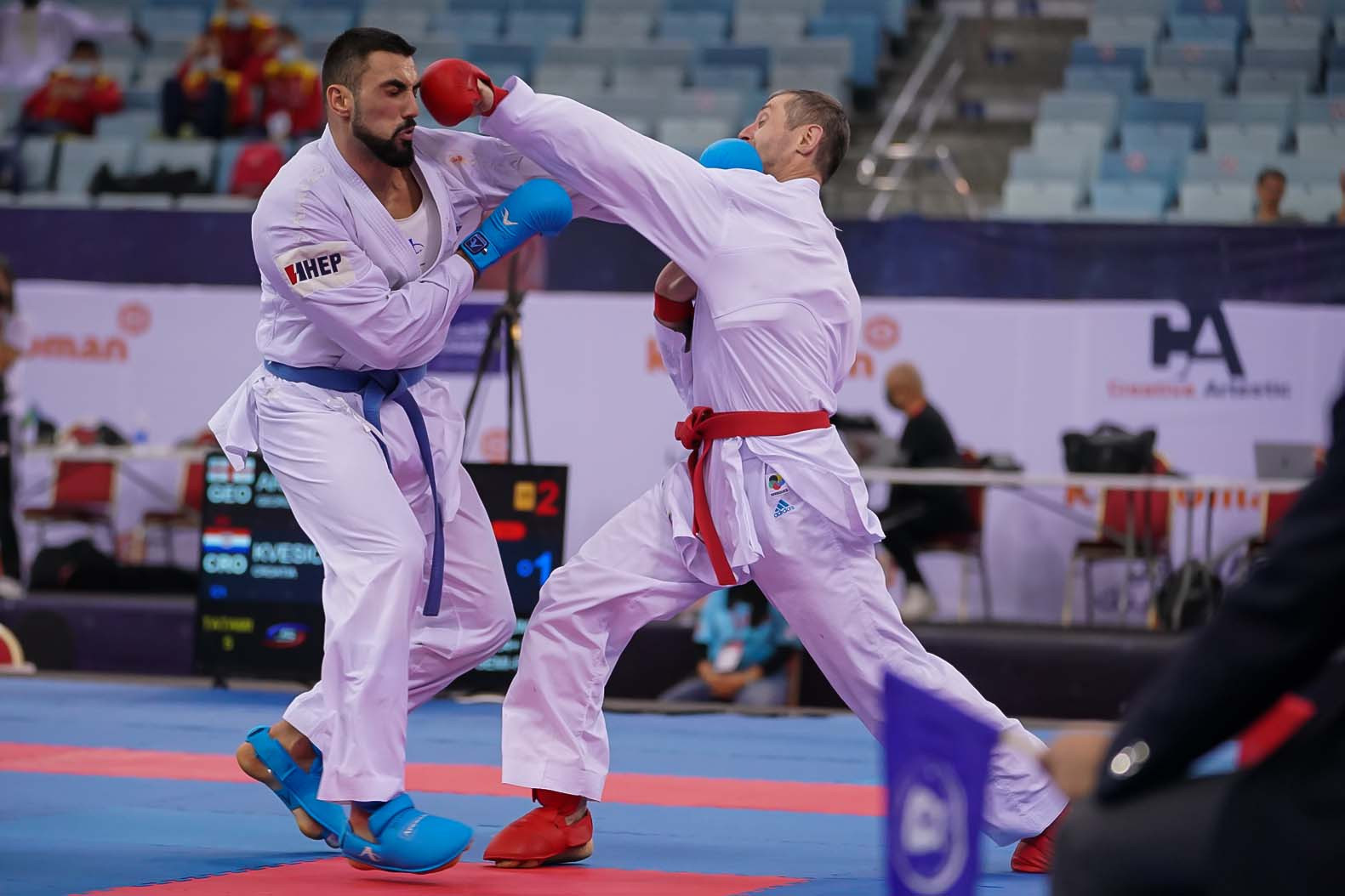 Gogita Arkania of Georgia, right, rolled back the years on his way to the men's over-84kg final ©WKF
