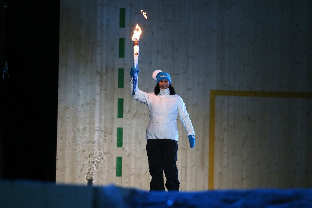 Six-time Olympic champion Marit Bjørgen carried the Olympic Torch into the arena ©YIS/IOC
