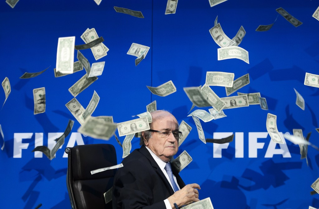 Sepp Blatter was showered in banknotes by comedian Simon Brodkin as the pressure grew during his presidency