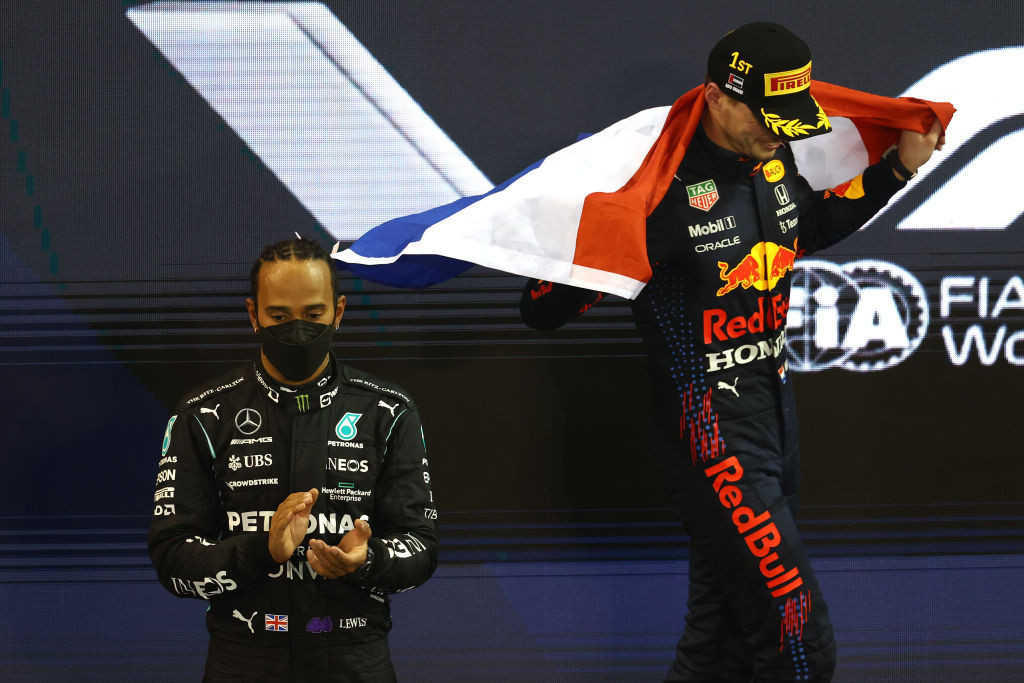 Max Verstappen celebrates as Lewis Hamilton applauds after the controversial final race of this season's Formula One World Championship ©Getty Images