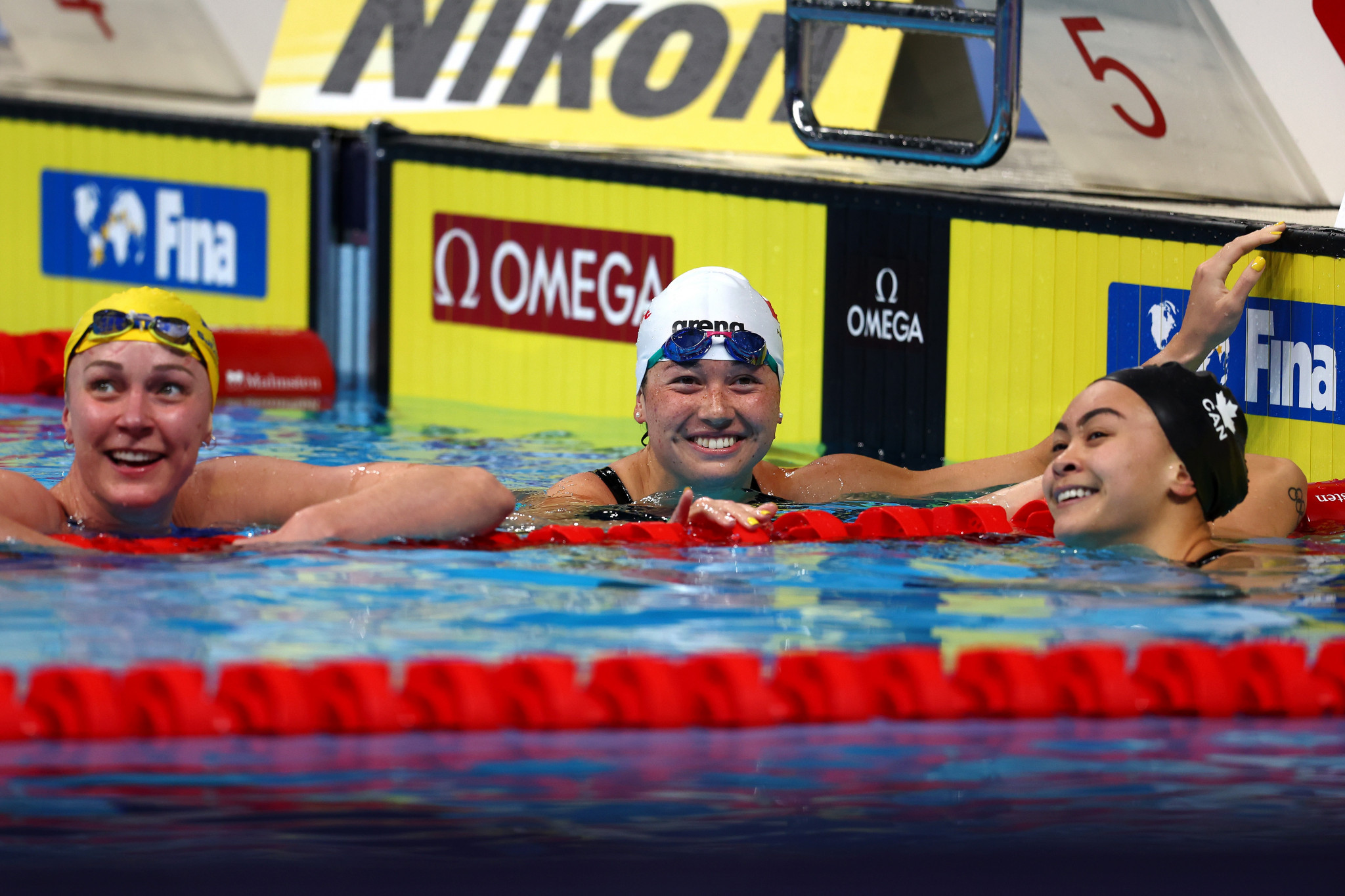 Hong Kong's Siobhán Haughey, centre, won the women's 100m freestyle title in a championship record time ©Getty Images