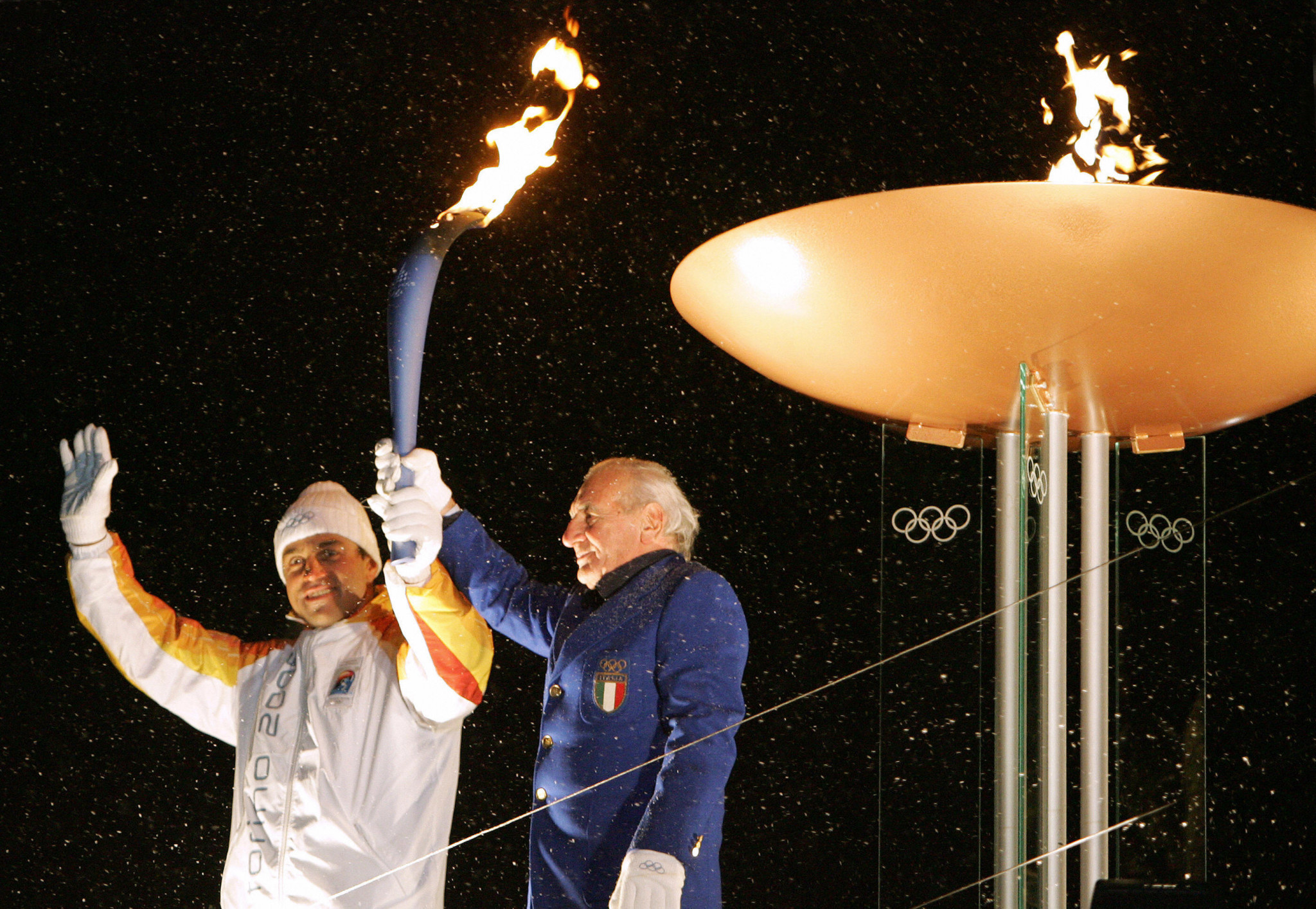 Guido Caroli, right, was the first athlete to light a Cauldron at a Winter Olympics in 1956 ©Getty Images