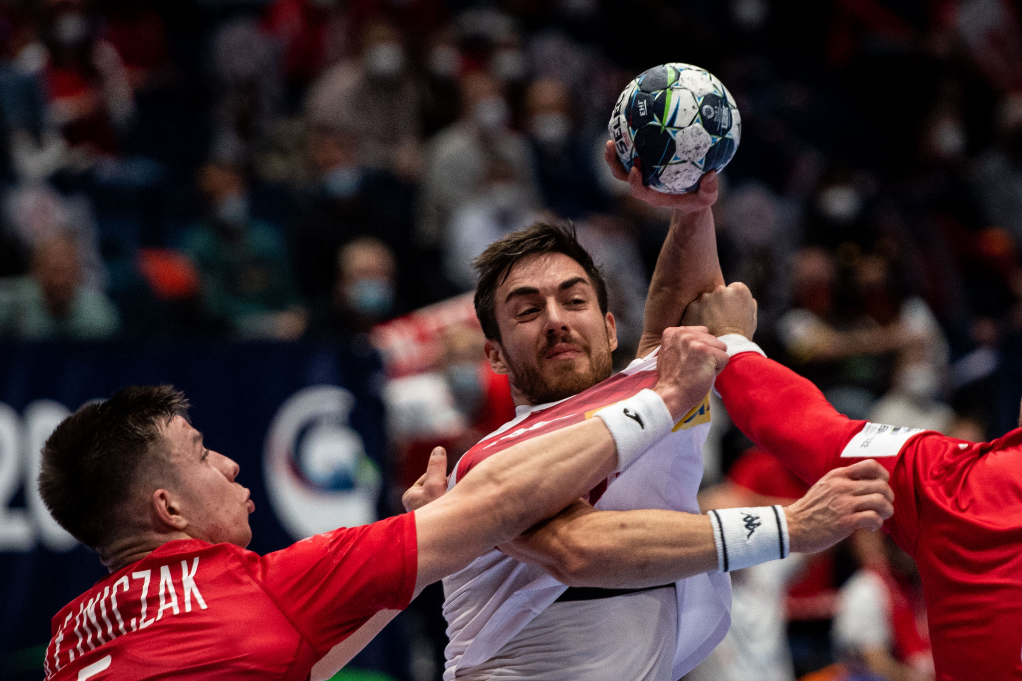 Poland, playing in red, defeated Austria in one of three preliminary round matches on day two of the men's European Handball Championship ©Getty Images 