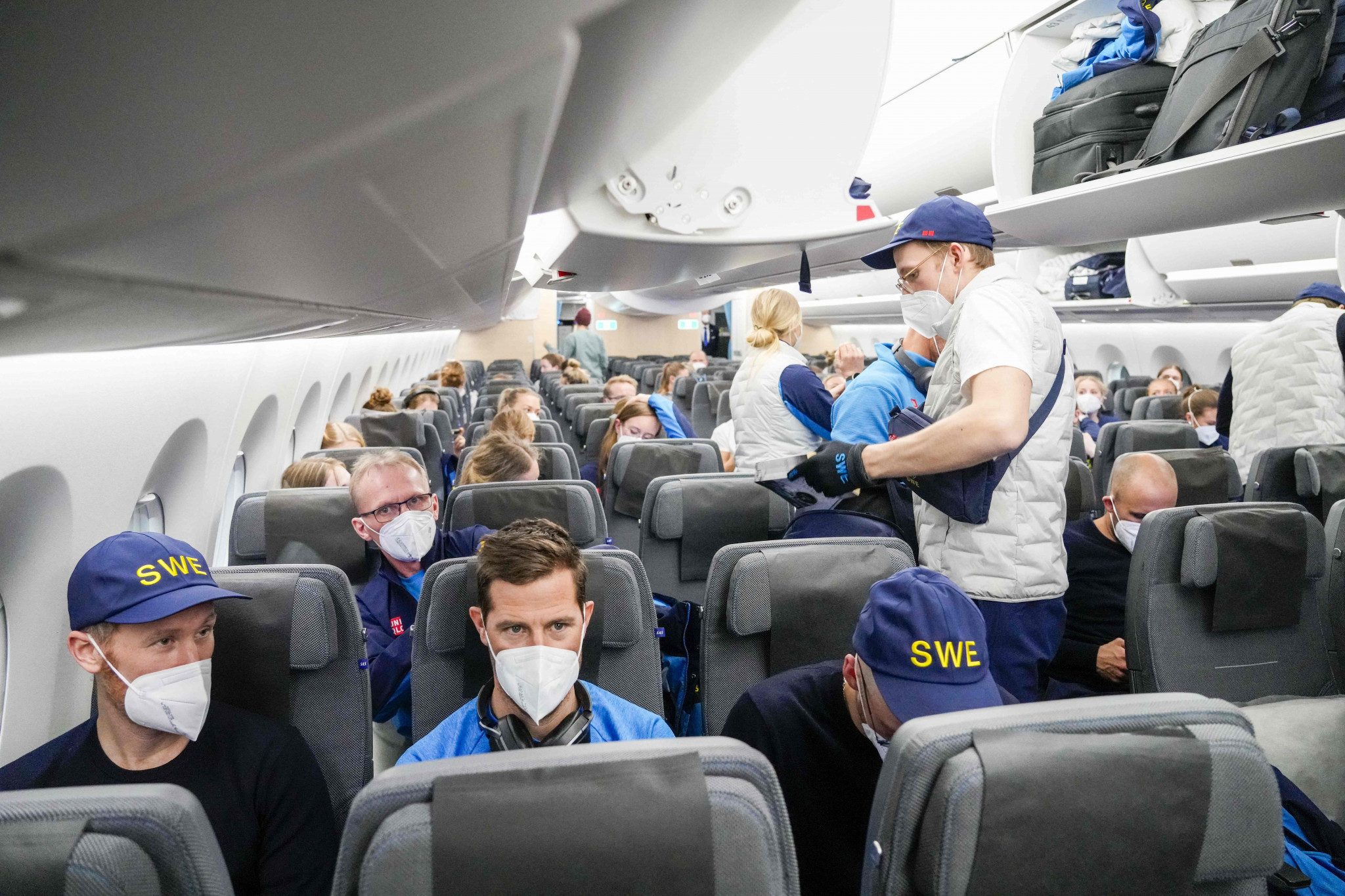 Norwegian, Swedish and Danish athletes, support staff, coaches and members of the press sit onboard a charter plane to Beijing ©Getty Images