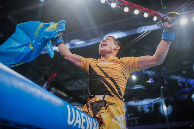 Bagdat Zhubanysh celebrated a third world title on top of the cage ©IMMAF