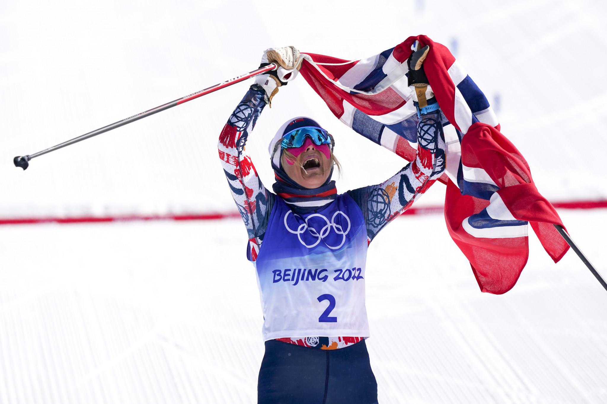 Johaug completes golden hat-trick with dominant mass start win at Beijing 2022