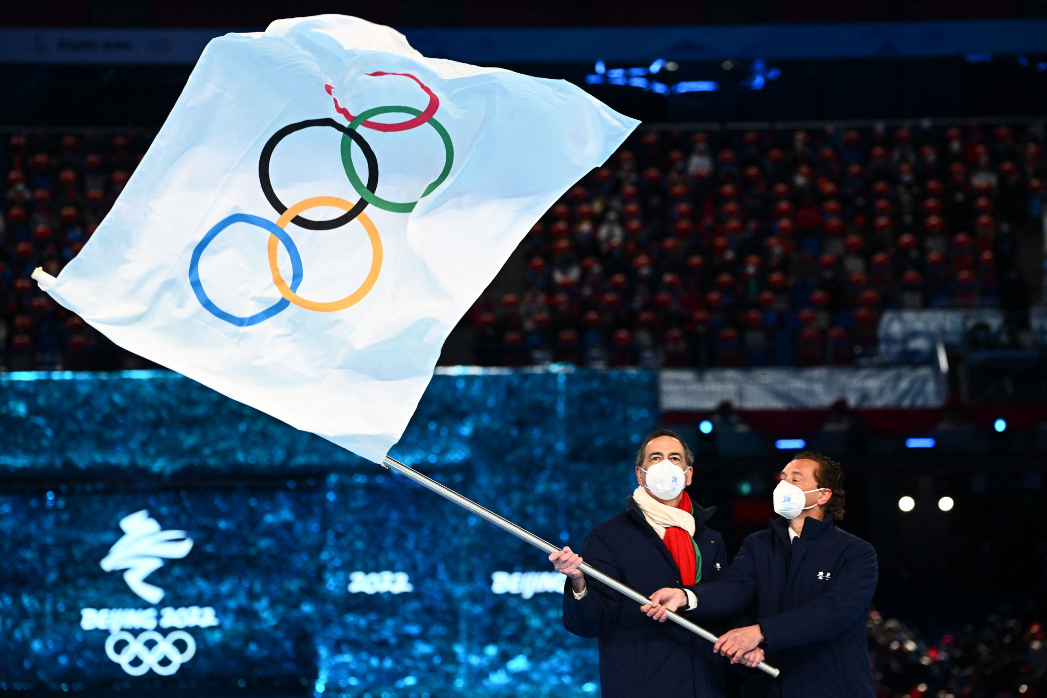Mayors Giuseppe Sala and Gianpietro Ghedina wave the Olympic Handover Flag at the Beijing National Stadium ©Getty Images