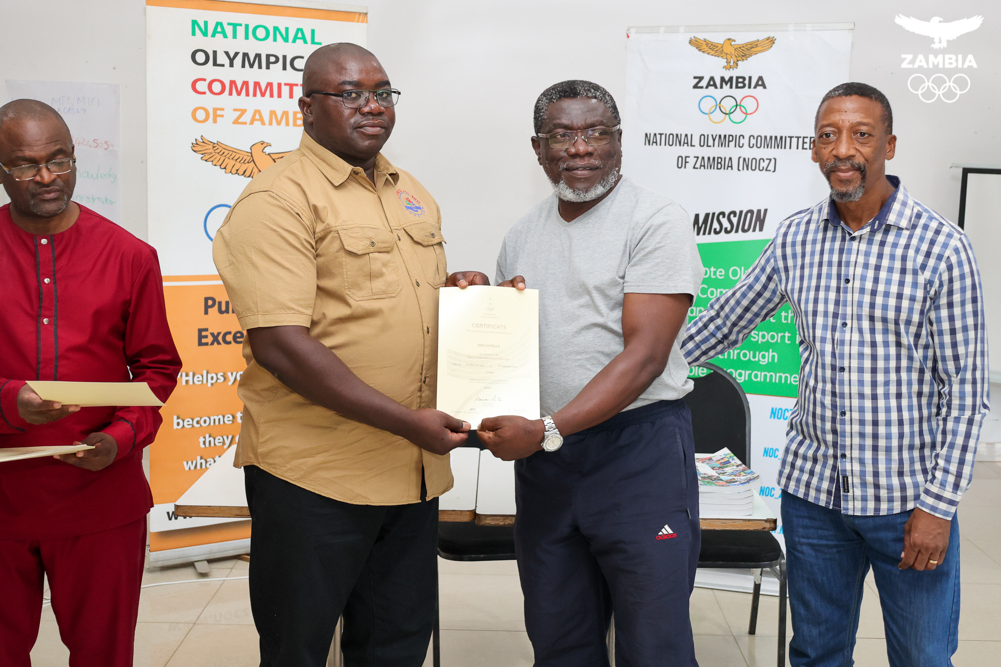 NOCZ President Alfred Foloko, second left, presented Zambia Boxing Federation President Dan Chiteule with a certificate ©NOCZ