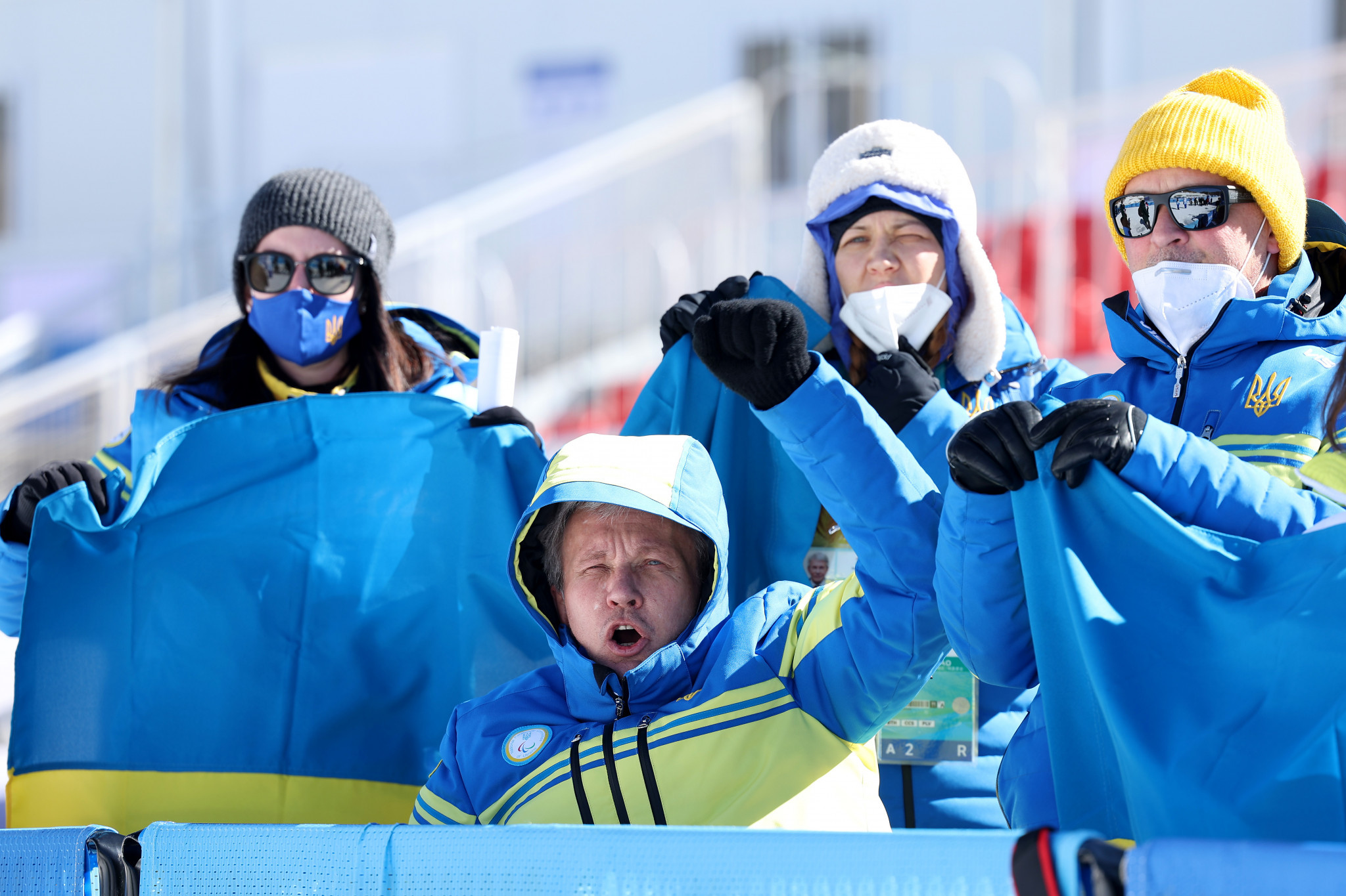The Ukraine delegation celebrate Grygorii Vovchynskyi winning gold in the men's biathlon sprint standing event ©Getty Images