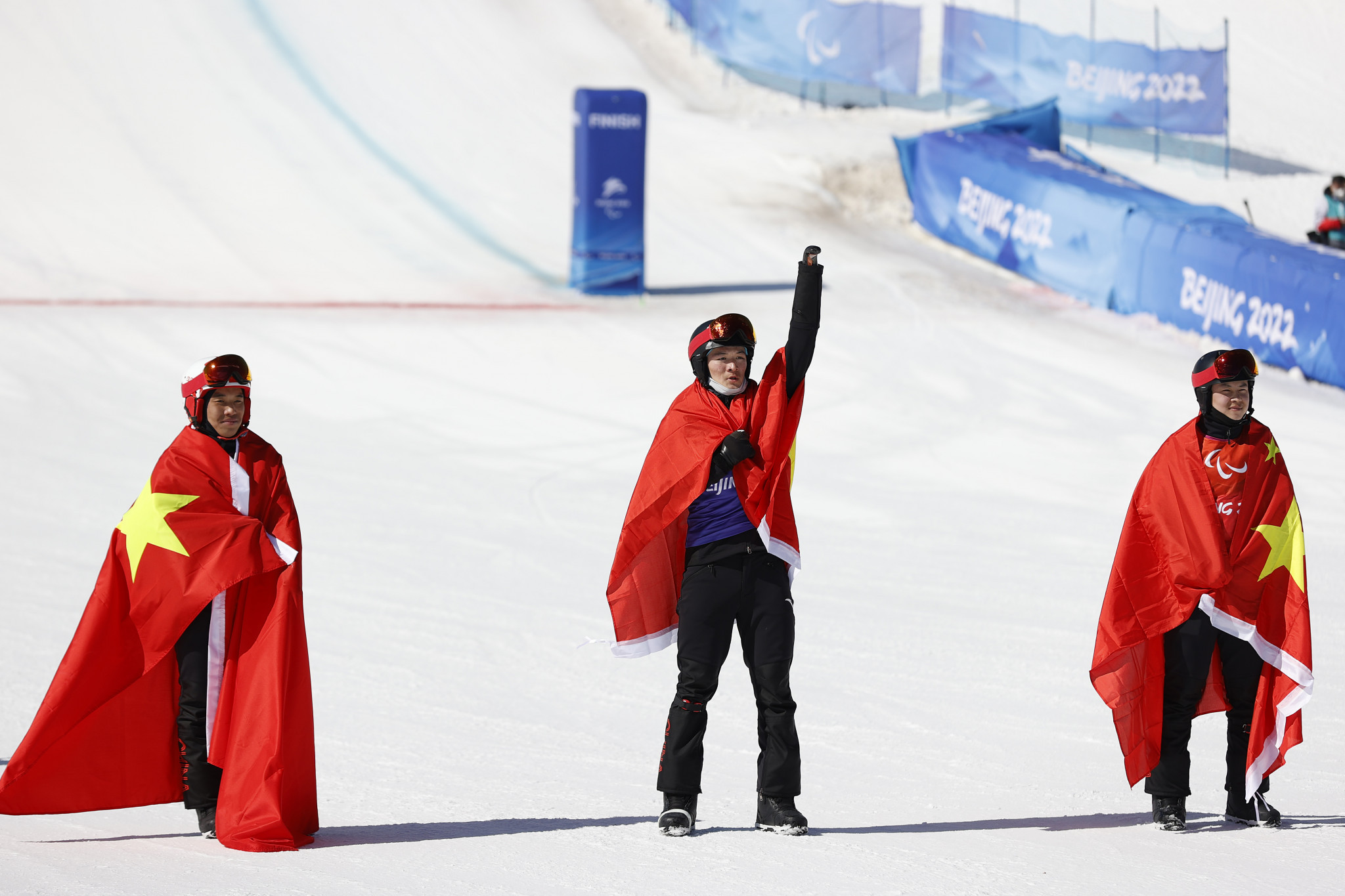Ji Lijia, centre, led a Chinese podium sweep in the men's SB-UL snowboard cross ©Getty Images