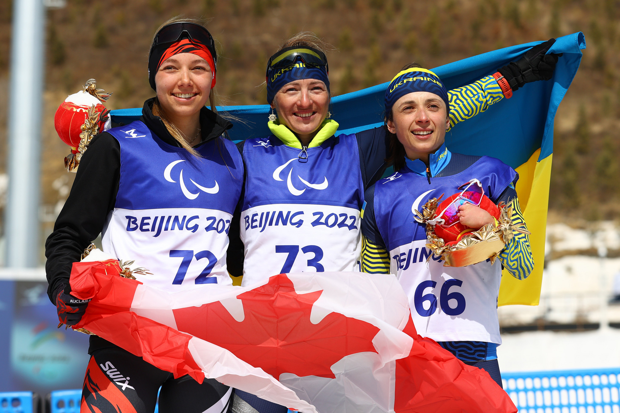 Canada's Natalie Wilkie, left, finished between Ukrainians Oleksandra Kononova, centre, and Iryna Bui in the women's cross-country skiing middle-distance standing ©Getty Images