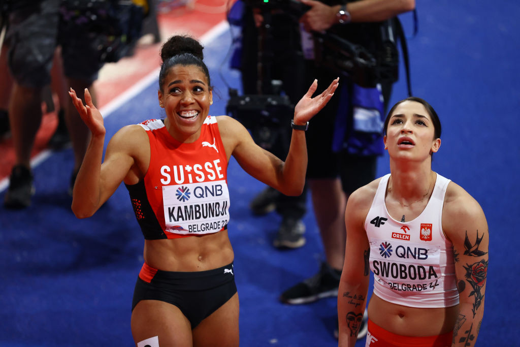 Switzerland's Mujinga Kambundji takes in her shock world indoor 60m victory in Belgrade as event favourite Ewa Swoboda of Poland reacts to her failure to reach the podium ©Getty Images