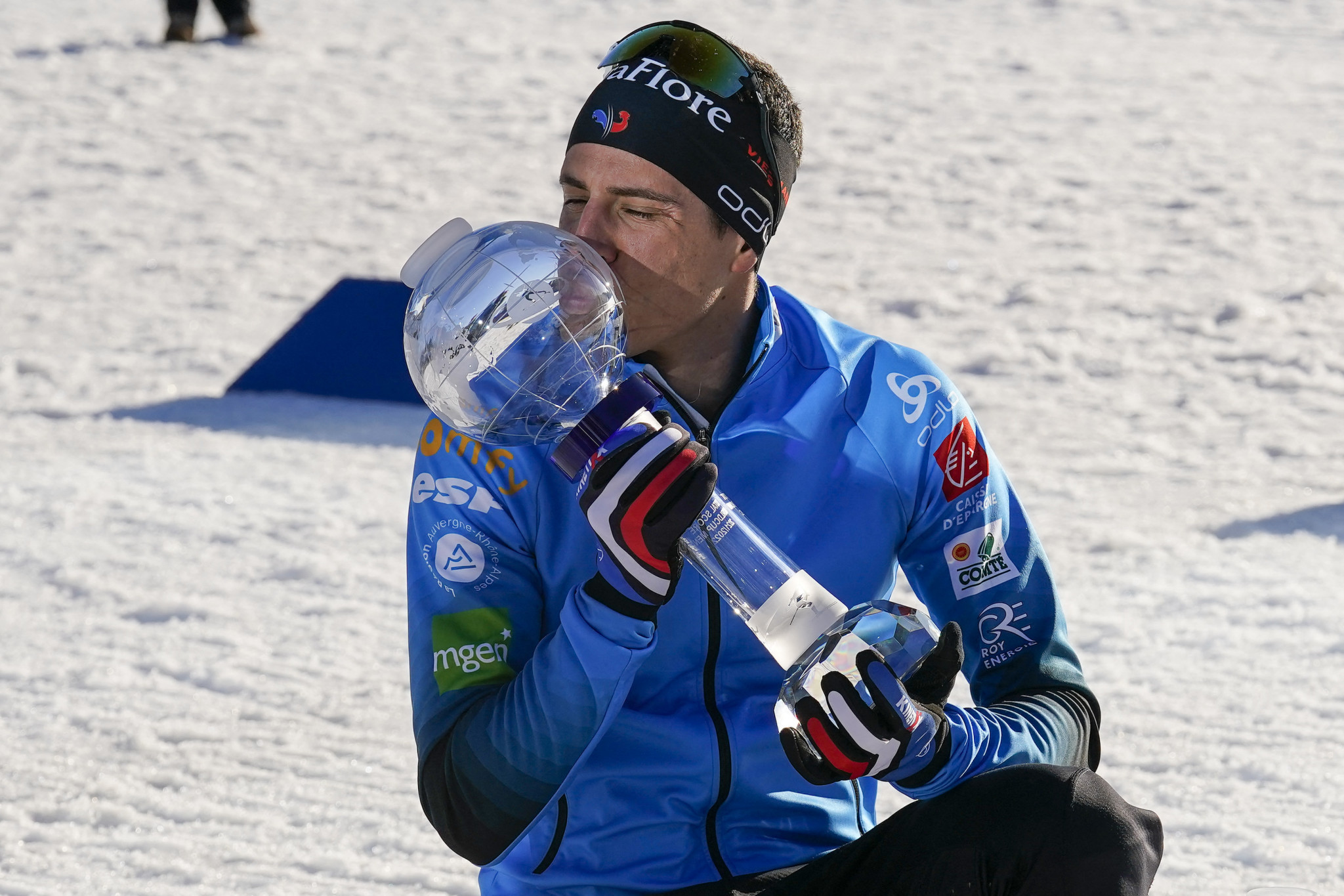 Quentin Fillon Maillet of France celebrates the victory by kissing the long-awaited trophy at the men's 15km mass start event of the IBU Biathlon World Cup in Holmenkollen ©Getty Images