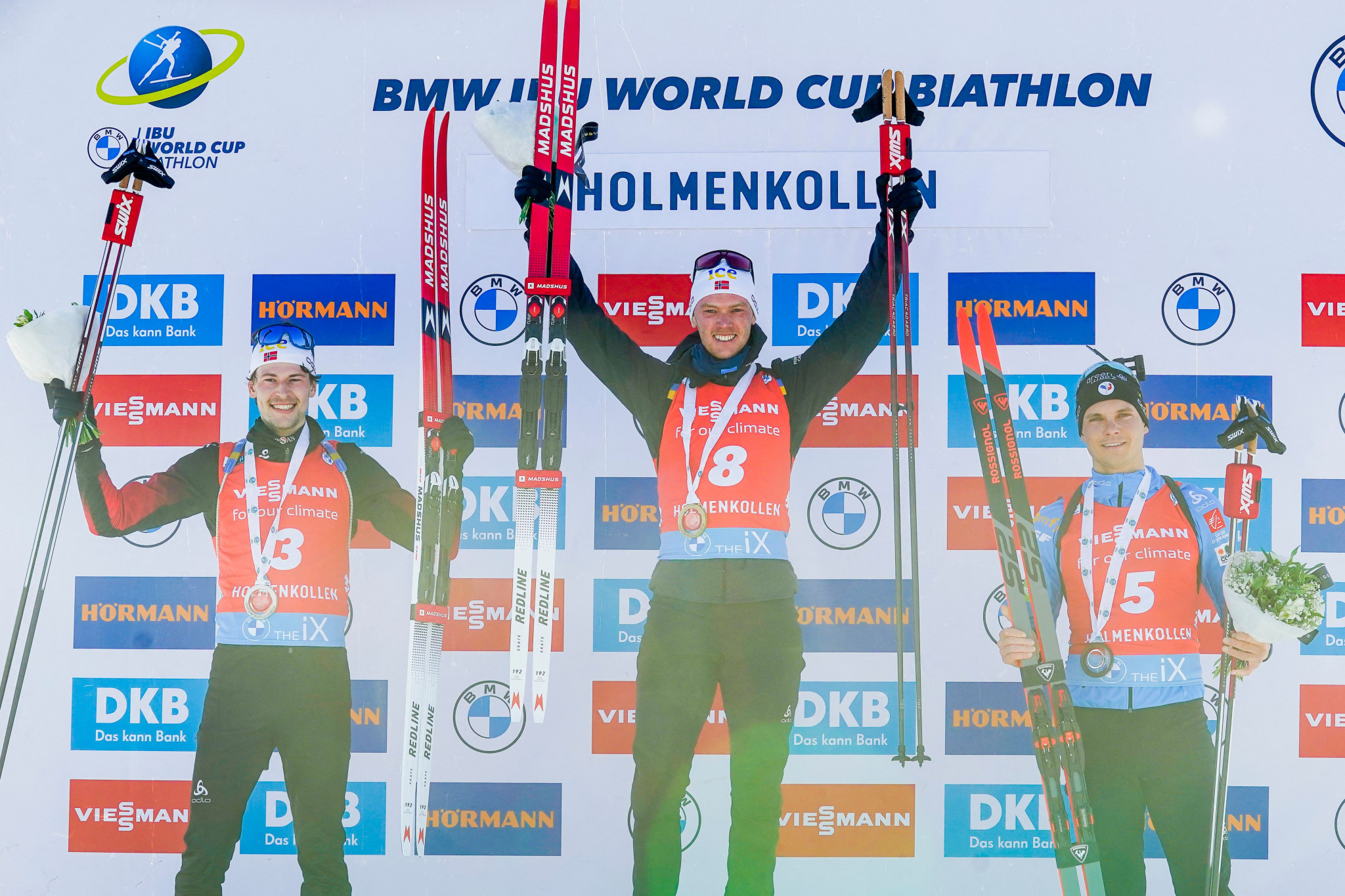 Second placed Sturla Holm Laegreid of Norway, winner Sivert Guttorm Bakken of Norway and third placed Emilien Jacquelin of France celebrate on the podium after the men's 15km mass start event at the IBU Biathlon World Cup in Holmenkollen, Oslo ©Getty Images