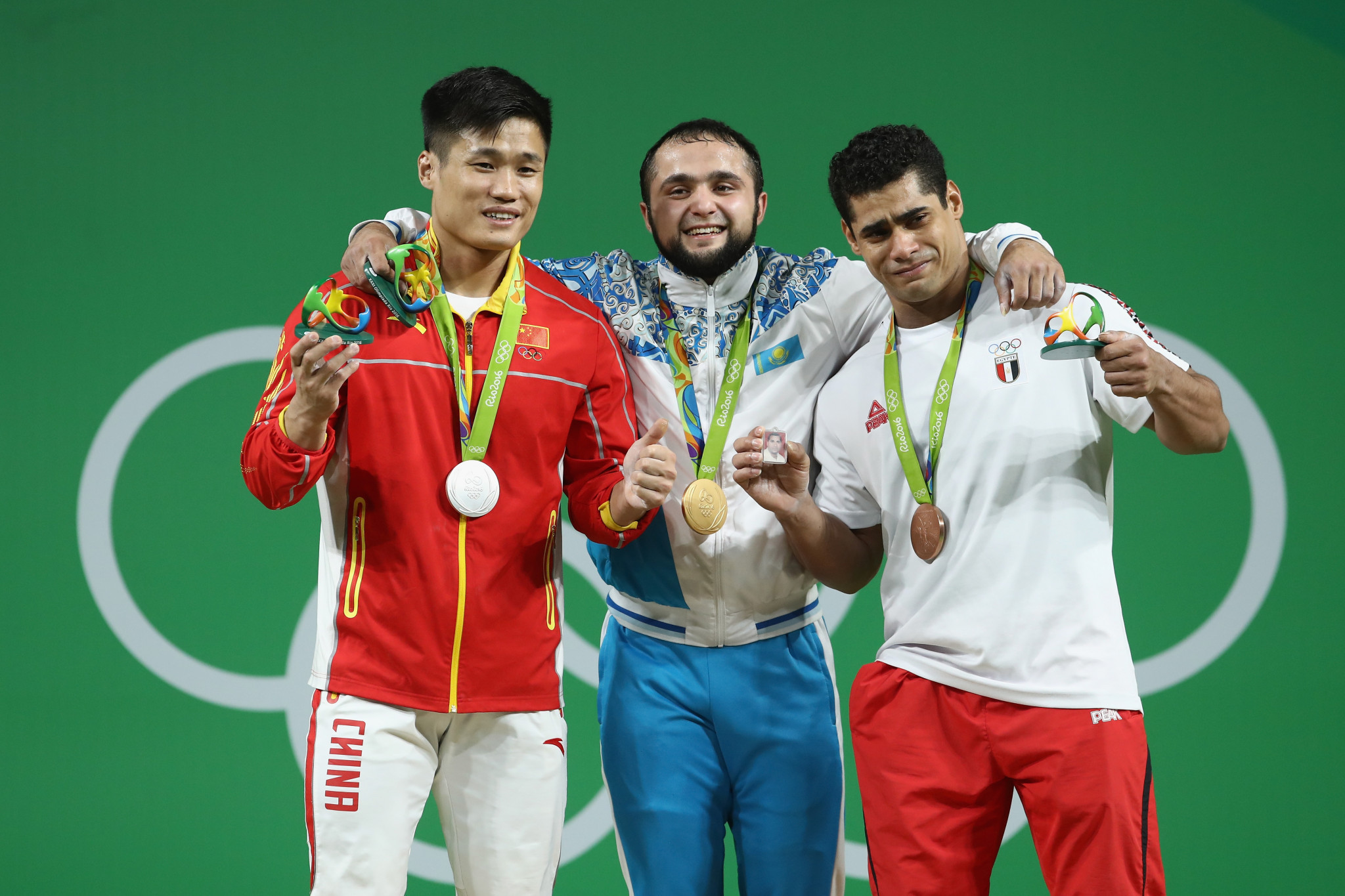 Nijat Rahimov, centre, along with Lu Xiaojun, left, and Mohamed Ehab, right, during the men's 77kg medal ceremony at Rio 2016 ©Getty Images