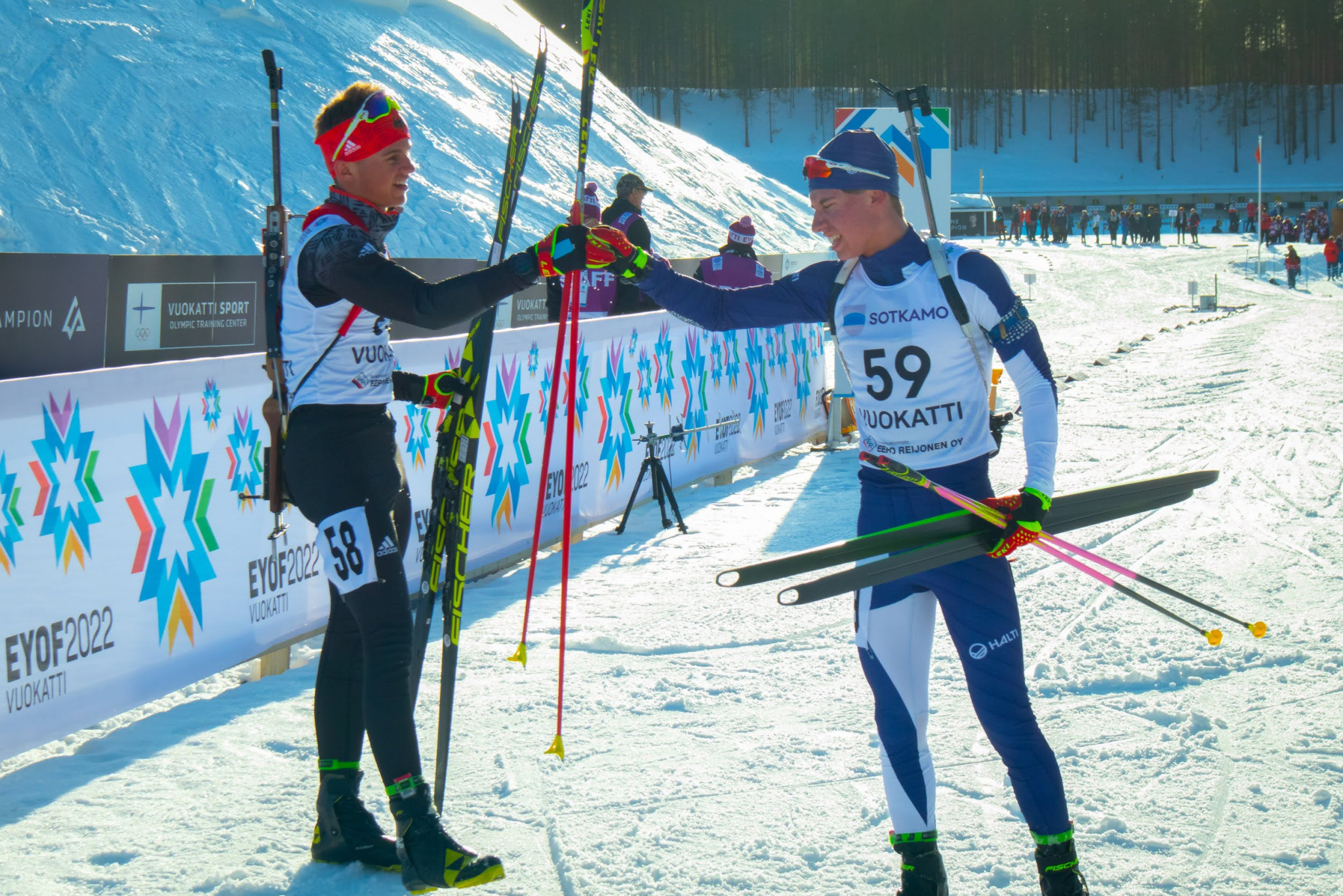 Germany's Paul Gunther, left, and Finland's Arttu Heikkinen, right, embrace at the finish line of the men's sprint 7.5k race on the first day of biathlon competition ©Konsta Koivisto/EYOF 2022 Vuokatti