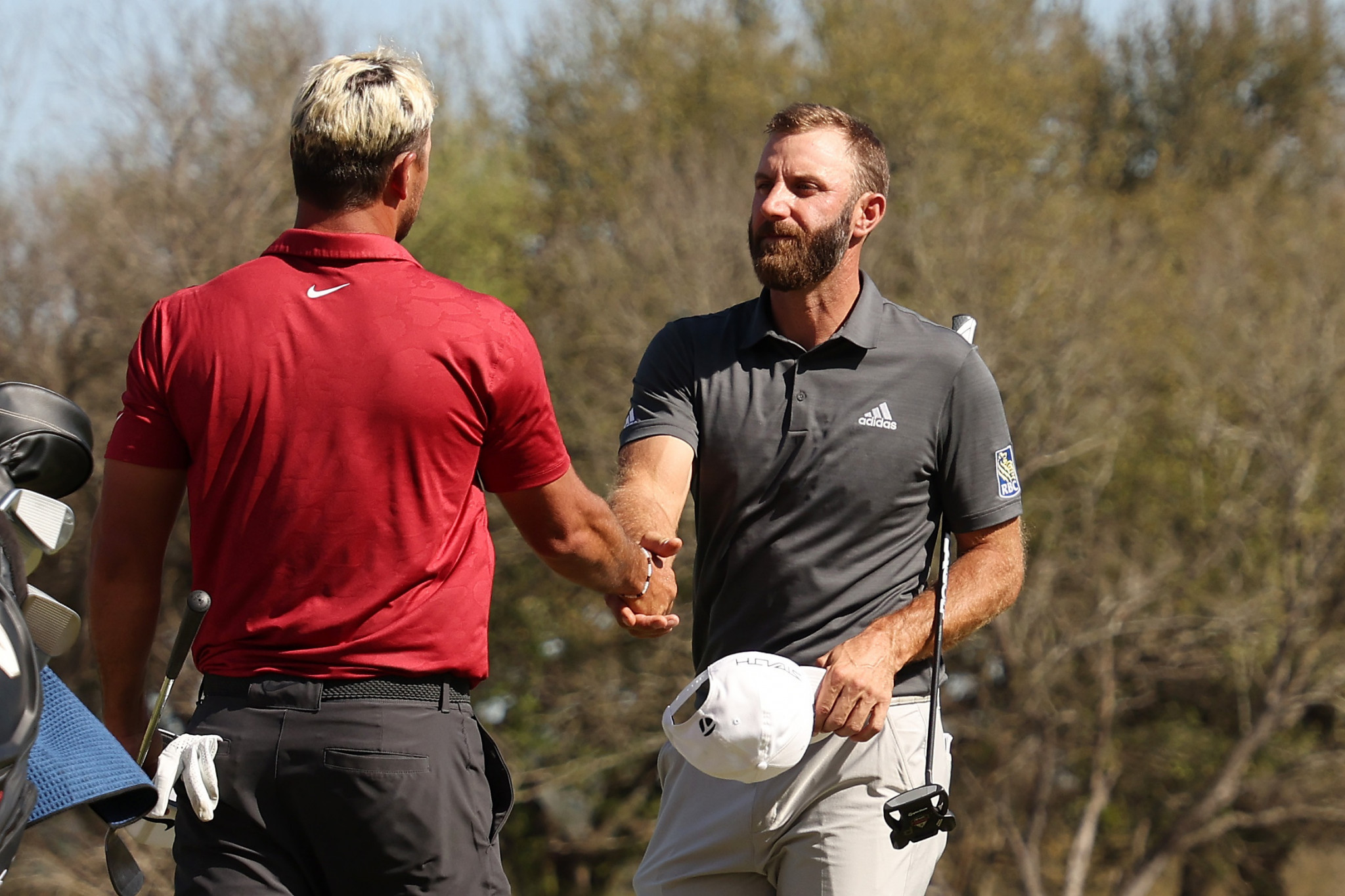 Dustin Johnson shakes Brooks Koepka's hand after beating his compatriot in an all-American quarter-final in Texas ©Getty Images