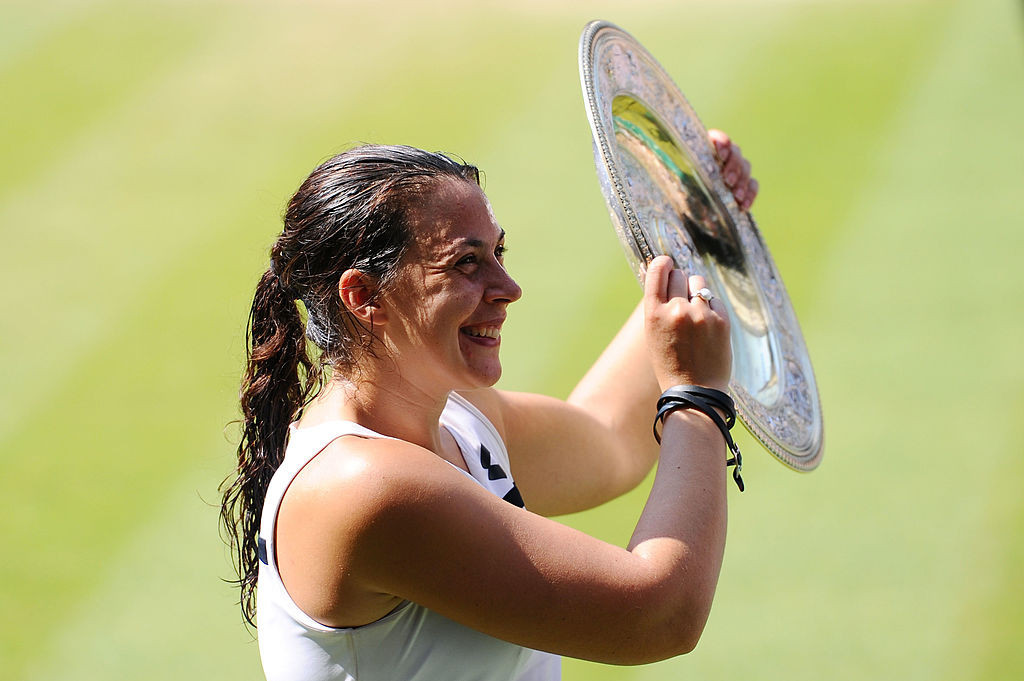 France's Marion Bartoli poses with the Venus Rosewater Dish trophy after winning the Wimbledon ladies' singles title in 2013, six years after losing in the final. She retired soon afterwards aged 28 ©Getty Images