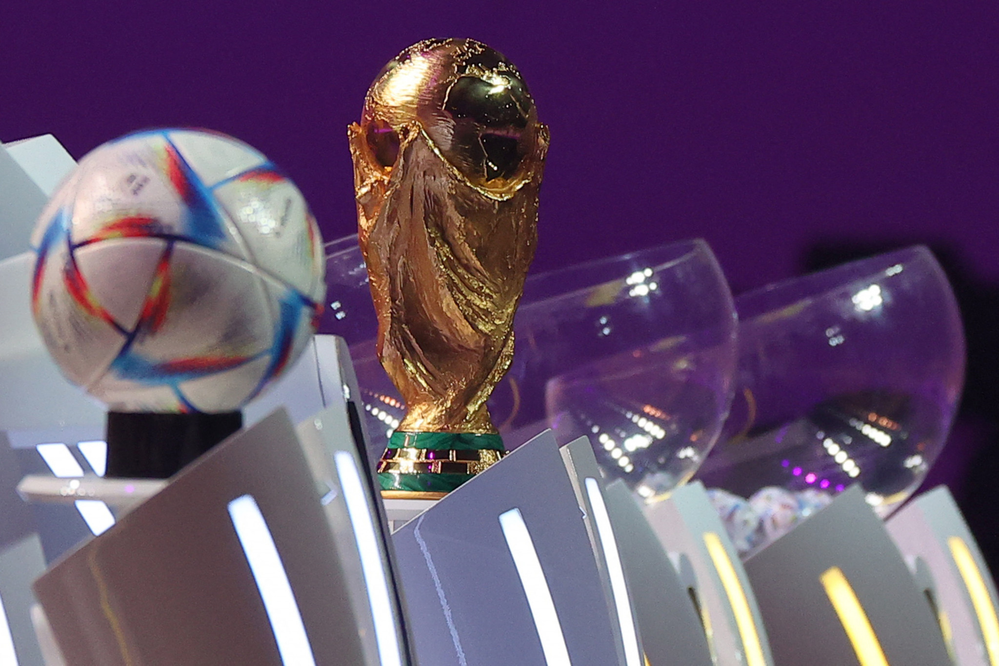 The FIFA World Cup trophy and the official 2022 World Cup ball, called Al-Rihla, were on show during the draw ©Getty Images