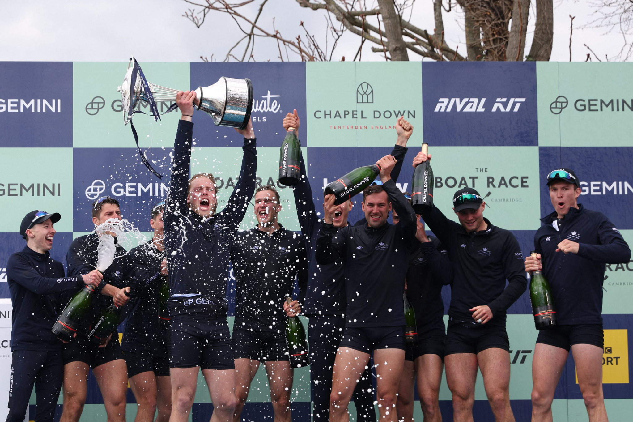 Oxford celebrate with the trophy during the podium ceremony after winning the 167th annual men's University Boat Race against Cambridge University ©Getty Images