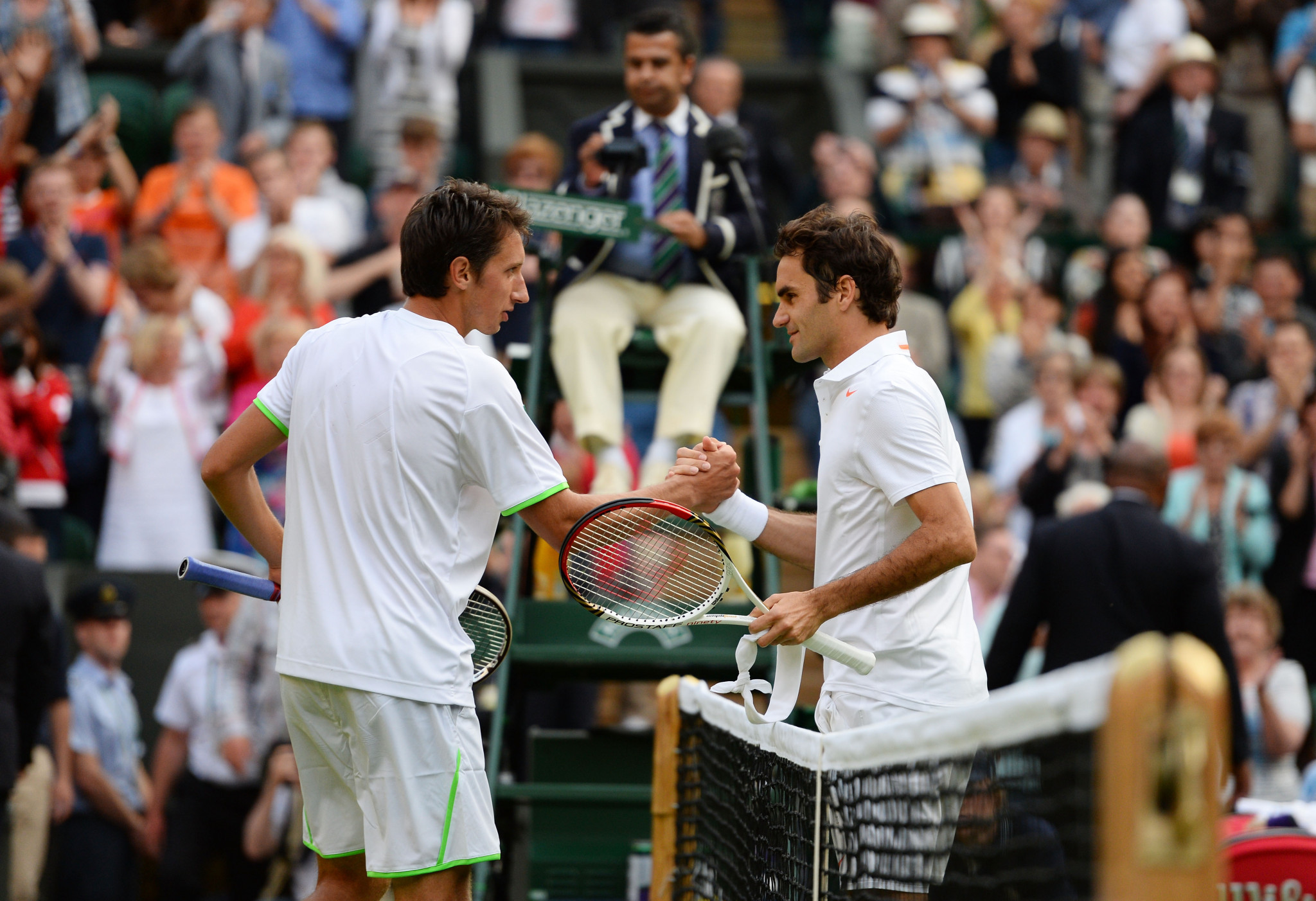 Wimbledon was the scene of Ukrainian Sergiy Stakhovsky's, left, most famous career victory against Roger Federer in 2013 ©Getty Images