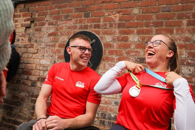 Hannah Cockroft tries out the adjustable ribbon on the medals for the Birmingham 2022 Commonwealth Games, which were unveiled today ©Lensi Photography