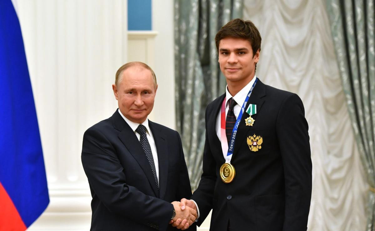 Russian President Vladimir Putin, left, has claimed a ban on double Olympic gold medallist Evgeny Rylov, right, is 