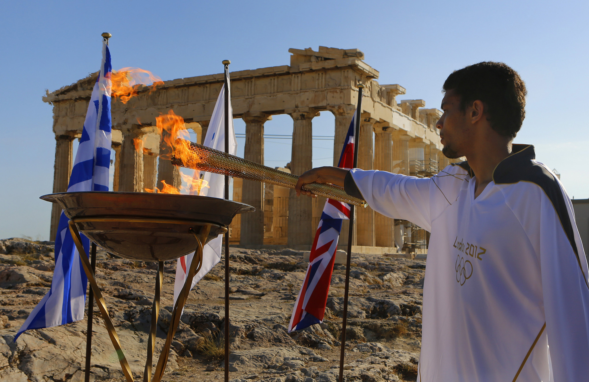 A traditional tripod was lit in front of the Parthenon by high jumper  Dimitrios Chondrokoukis who missed London 2012 after a positive doping test ©Getty Images