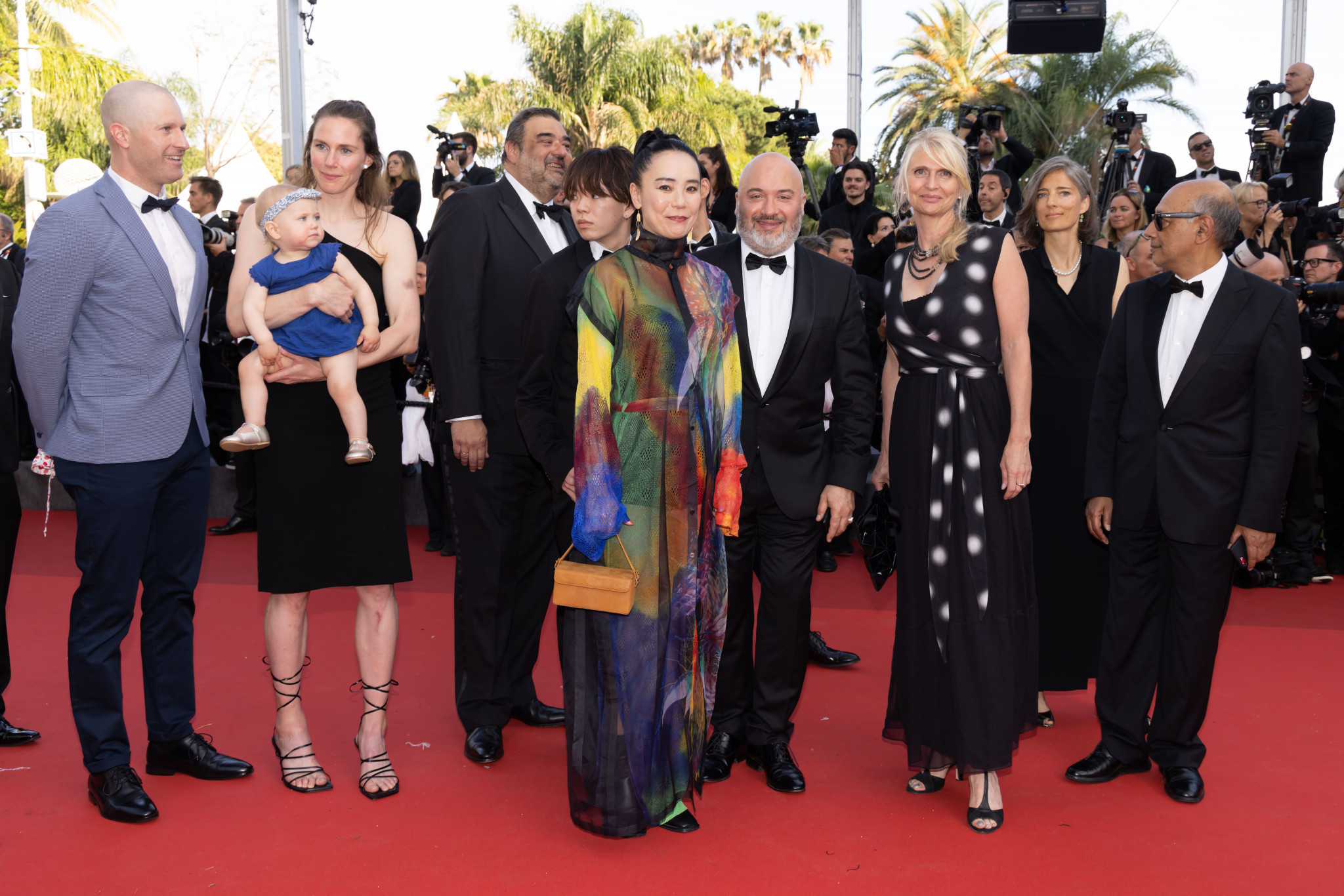 Olympic film director Naomi Kawase, centre, treads the red carpet at Cannes with Canadian basketball player Kim Goucher and baby Sophie who feature heavily in the film ©Kazuko Wakayama 