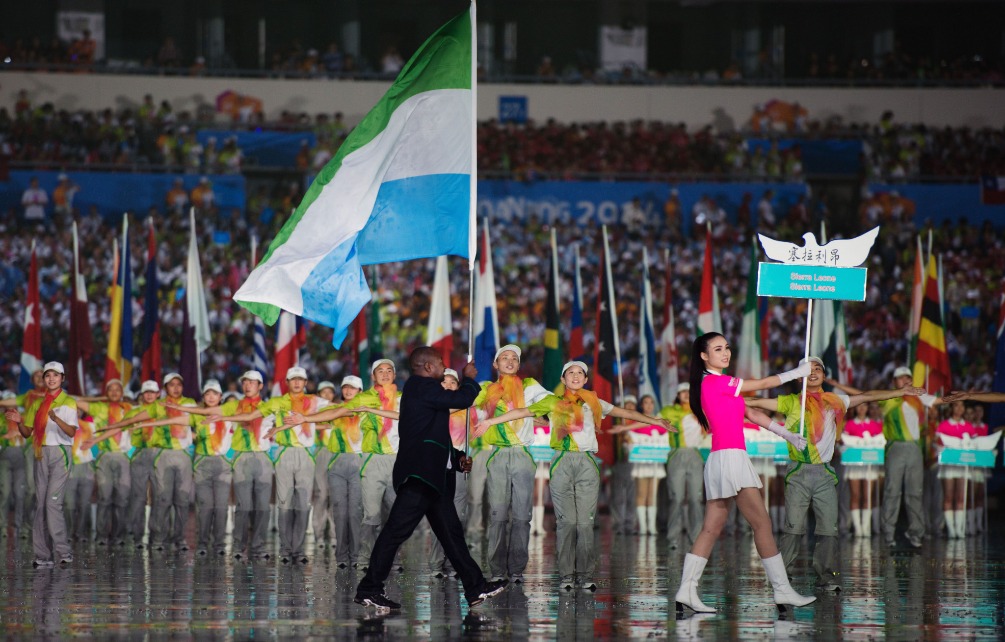 Unisa Deen Kargbo carried the Sierra Leone flag on his own at the Nanjing 2014 Summer Youth Olympic Games, where the country was banned from competing ©Getty Images