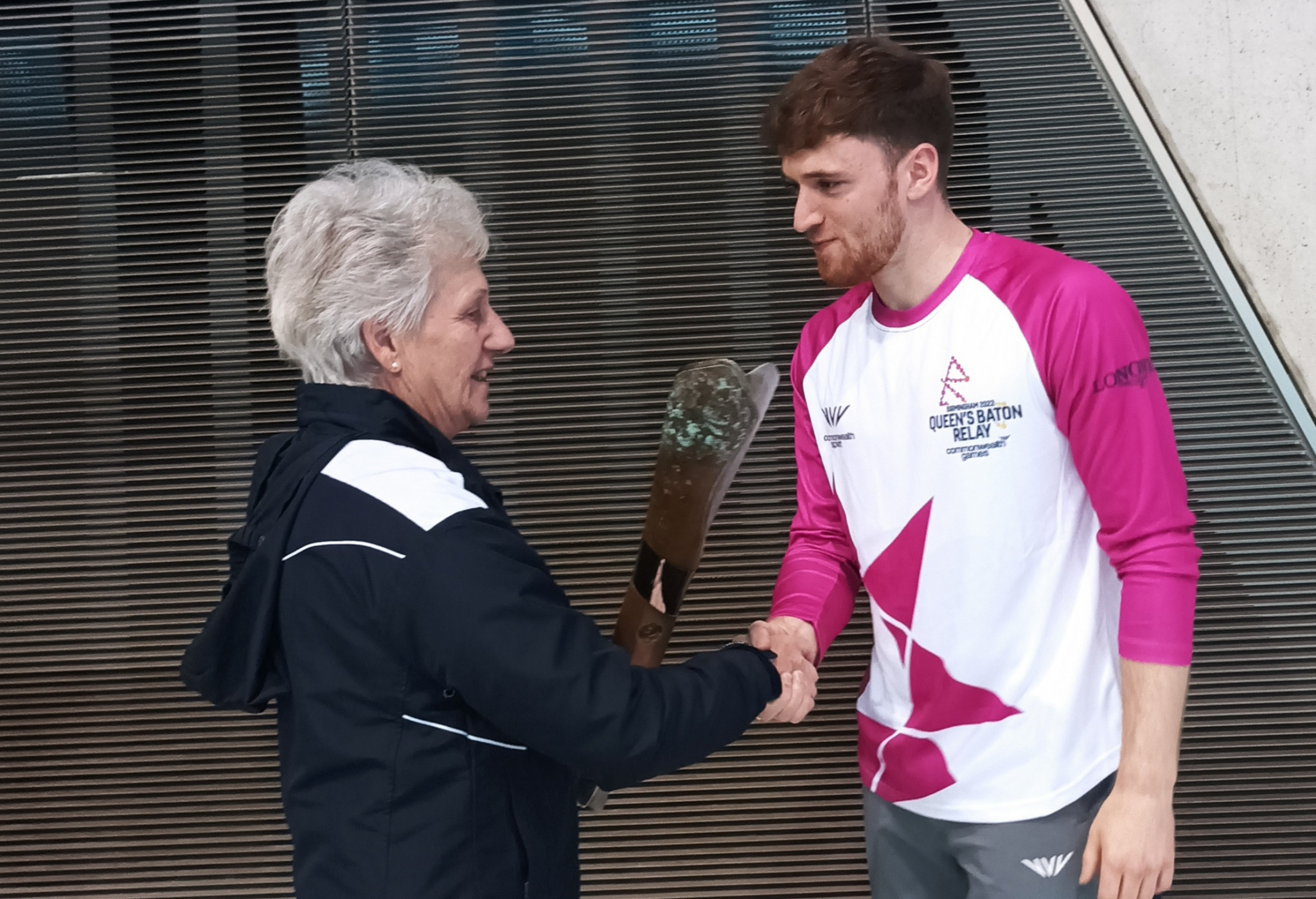 Dame Louise handed the Baton to Olympic synchronised diving champion Matty Lee before it flies to the Falkland Islands next week ©ITG