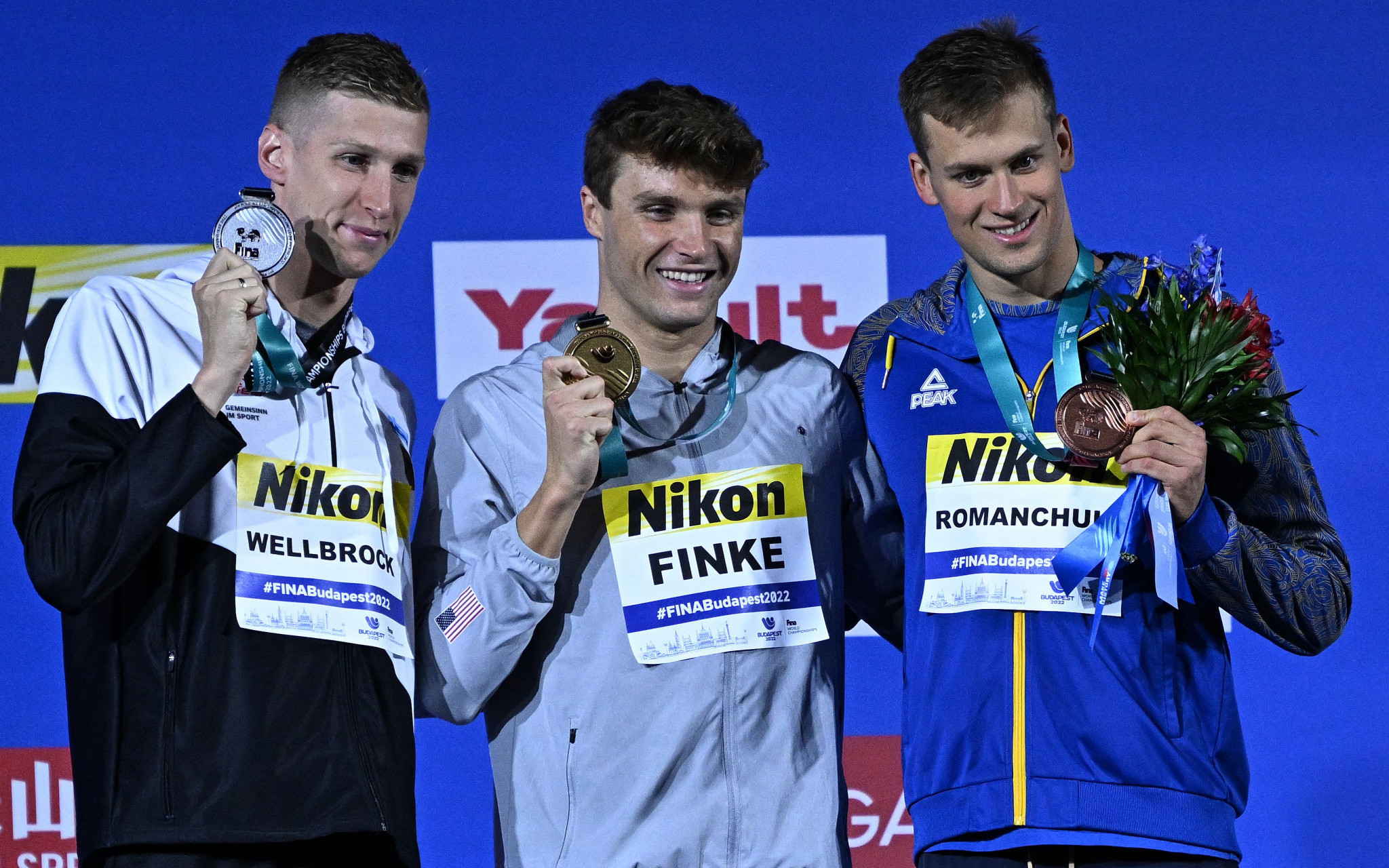 Bobby Finke of the US, centre, Germany's Florian Wellbrock, left, and Ukraine's Mykhailo Romanchuk, right, were separated by less than one second in the men's 800m freestyle final ©Getty Images