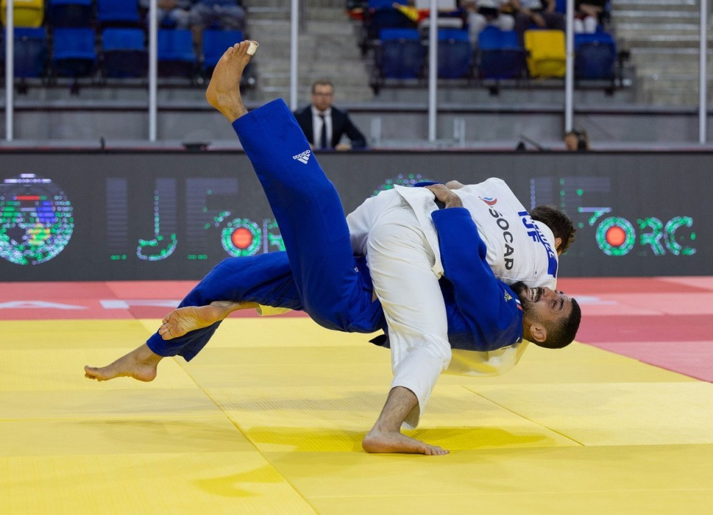 Yago Abuladze, in white, won bronze in the men's under-66kg category, competing as a neutral under the IJF flag ©IJF