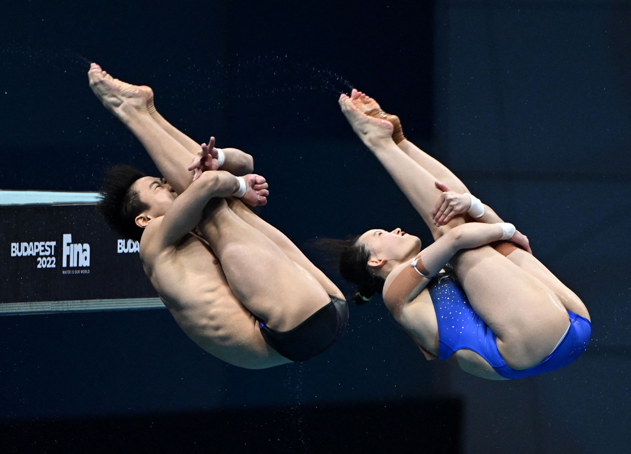 China's Duan Yu, left, and Ren Qian, right, topped the scoring in all five rounds of the mixed 10m platform synchronised diving event ©Getty Images