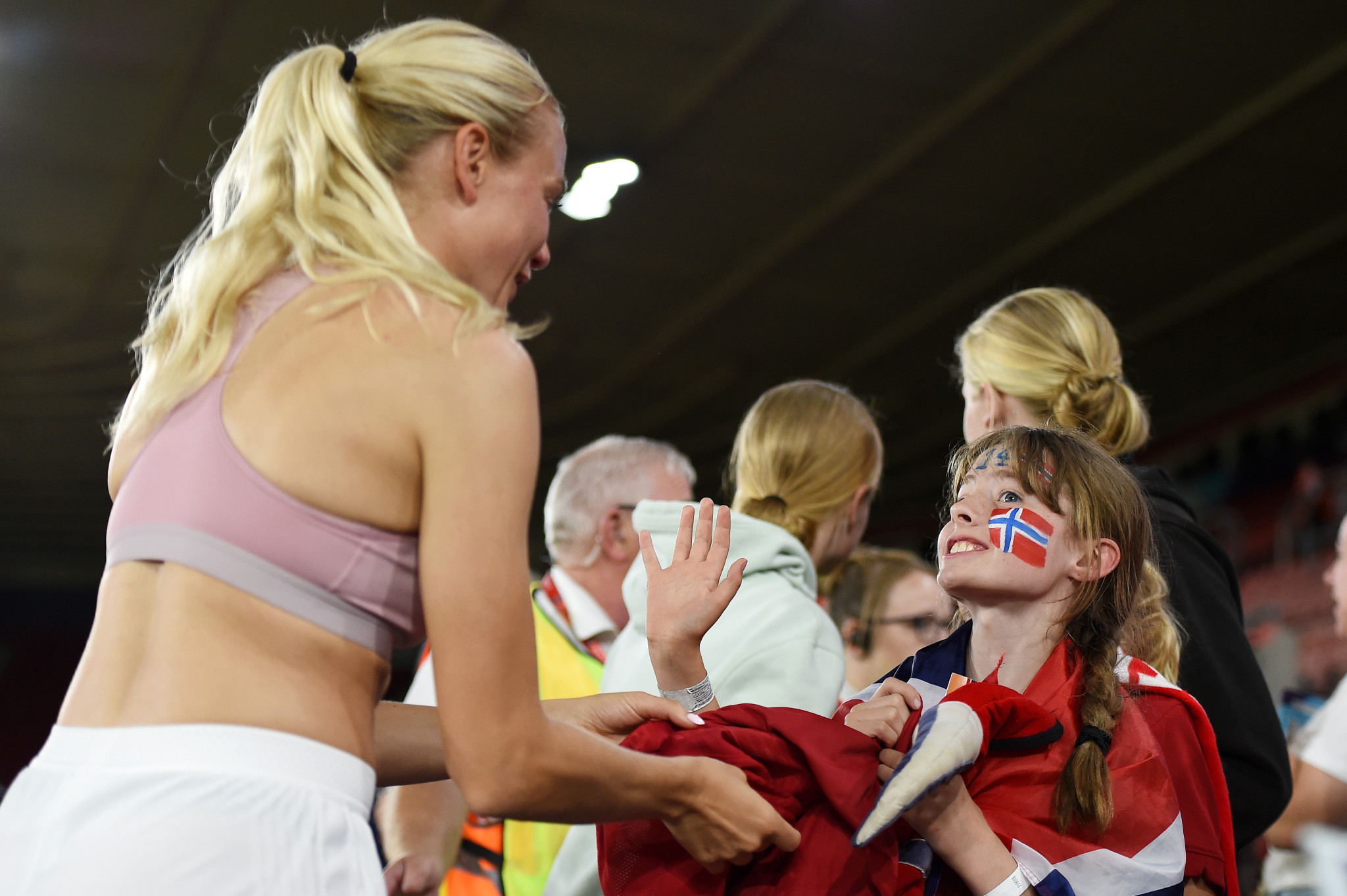 Norway's Guro Bergsvand gives her shirt to a young fan at the final whistle ©Getty Images
