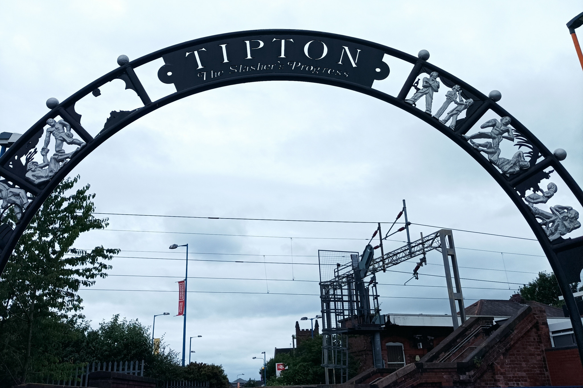 The archway at Tipton railway station depicting the career of William Perry ©ITG