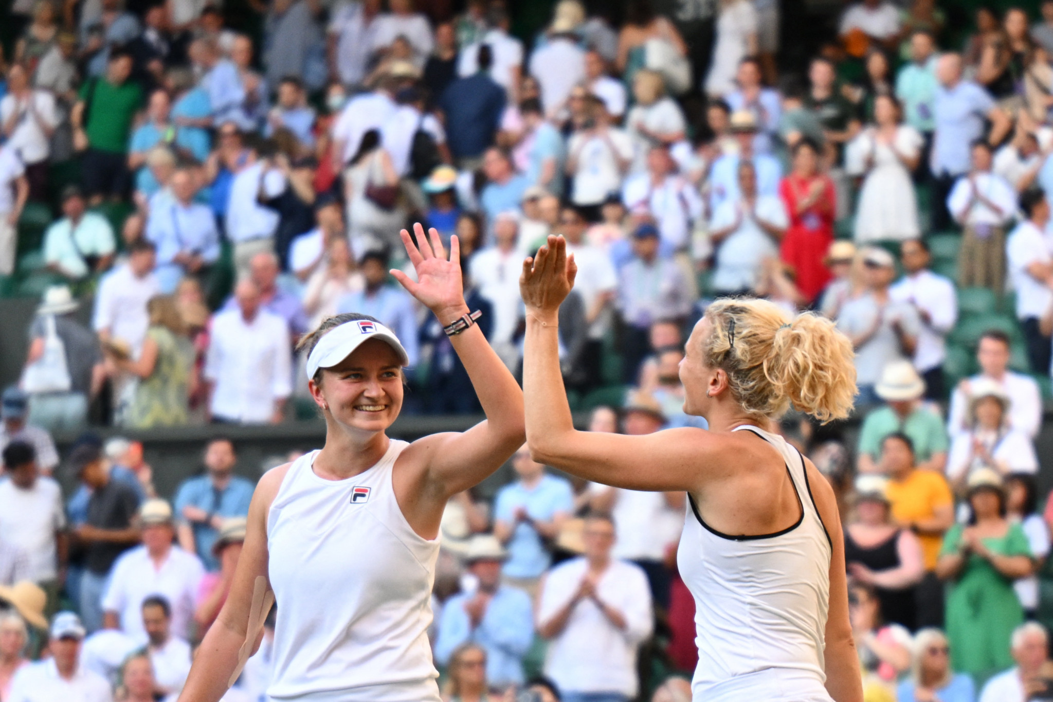 Barbora Krejčíková, left, and Kateřina Siniaková, right, celebrate winning their second women's doubles Wimbledon title against Elise Mertens and Zhang Shuai ©Getty Images