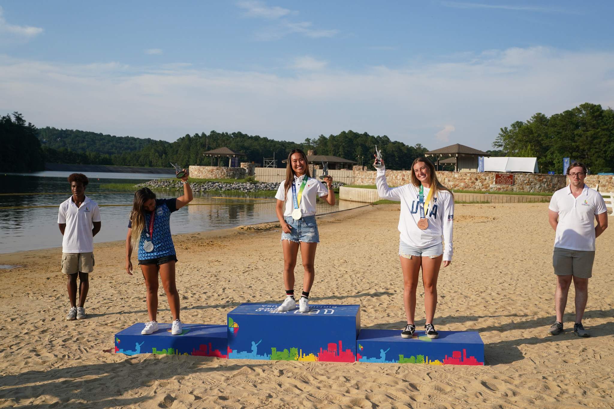 Eugenia de Arms, second to left, Hinata Yoshihara, centre, and Taylor McCullough celebrate winning medals in the women's wakeboard freestyle ©The World Games 2022/Marvin Gentry