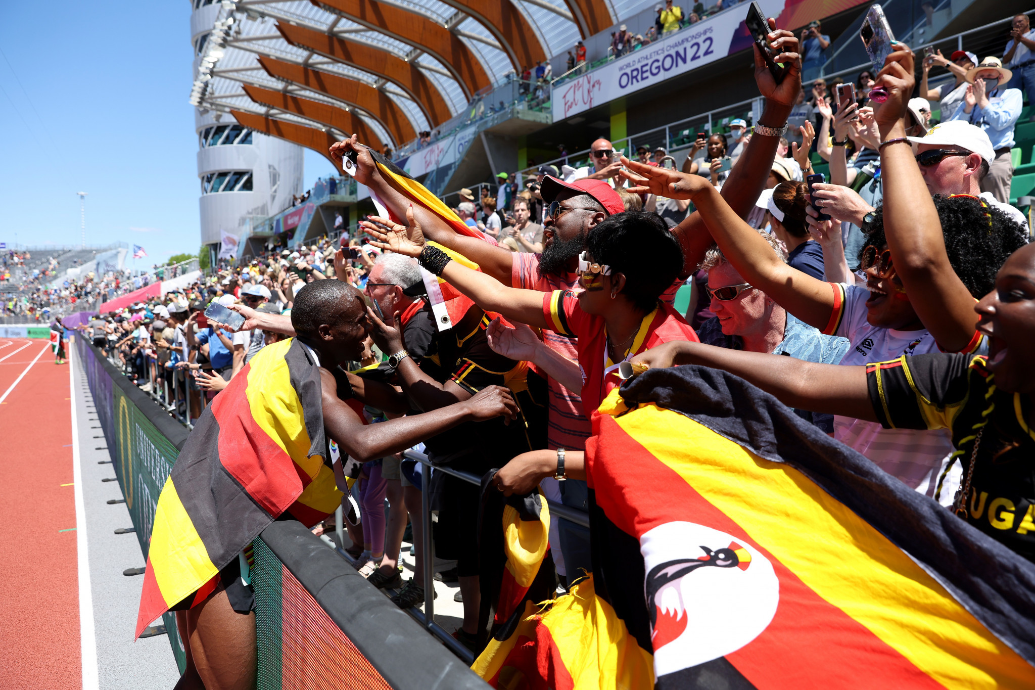 Joshua Cheptegei of Uganda celebrates with his fans after winning the men's 10,000m title in Oregon ©Getty Images