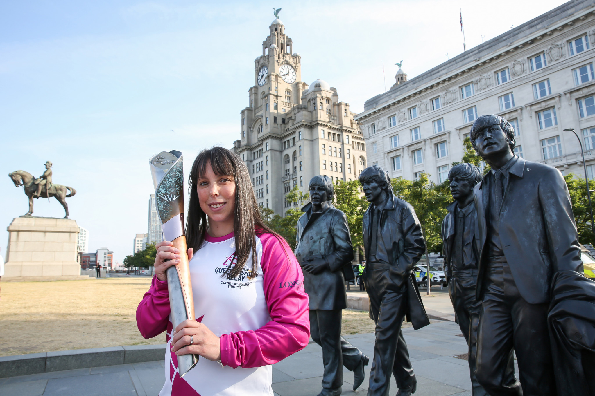 Statues of John Lennon, Paul McCartney, George Harrison and Ringo Starr watched over gymnast Beth Tweddle as she carried the Queen's Baton in Liverpool ©Getty Images