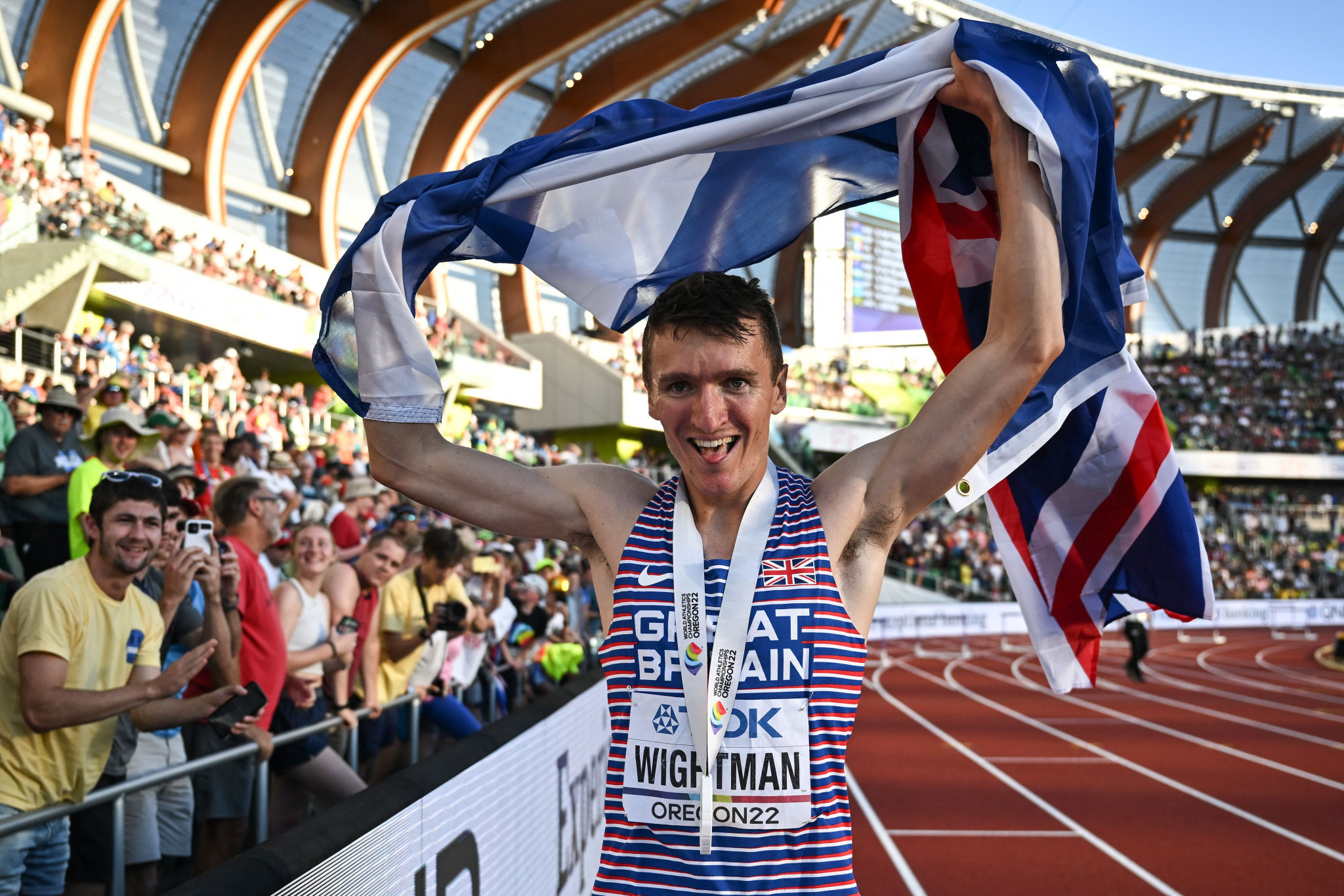 Jake Wightman carrying the Scottish and British flags when celebrating his men's 1500m win ©Getty Images